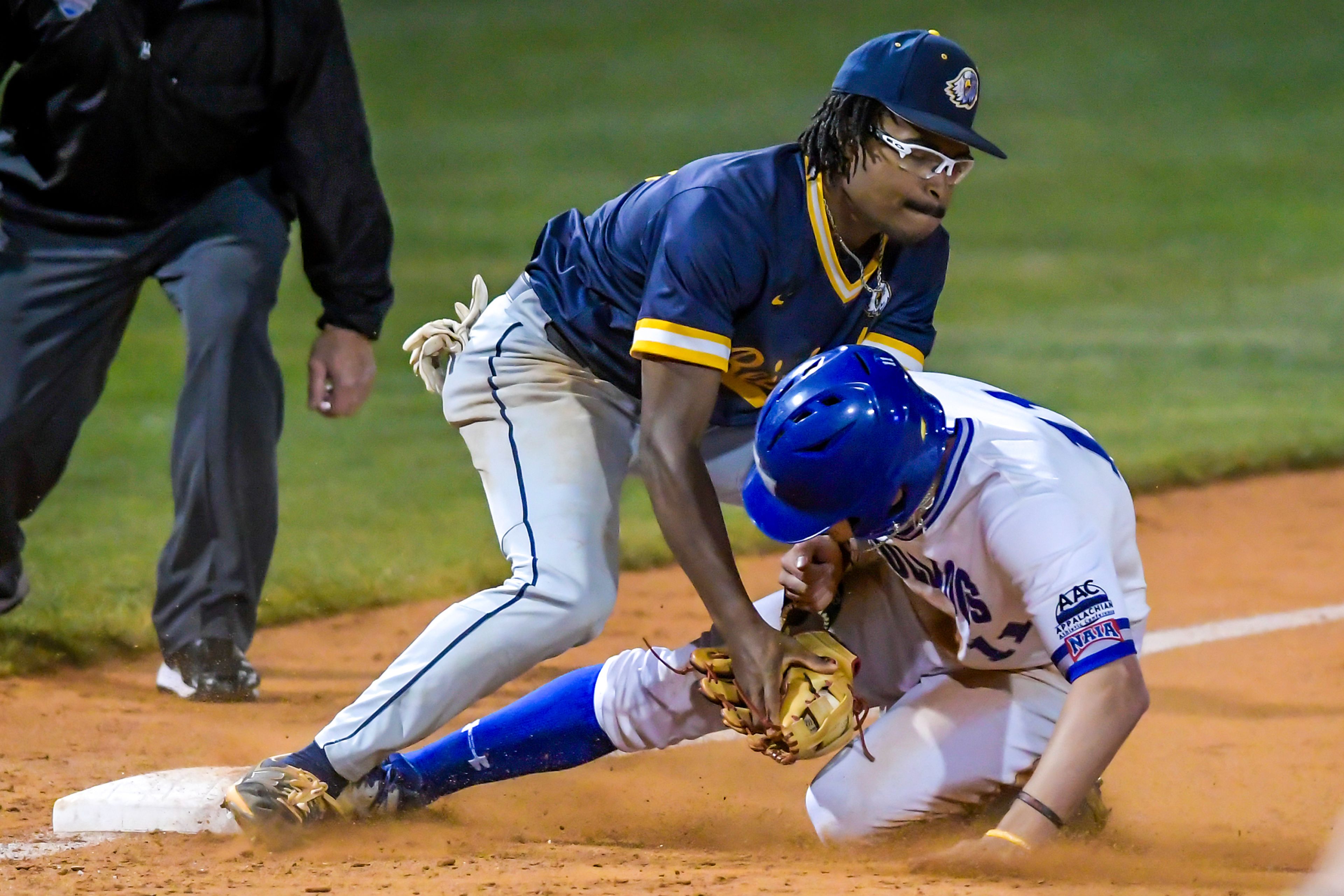 Reinhardt third baseman Jarrett Burney tags out Tennessee Wesleyan’s Carson Ford in Game 18 of the NAIA World Series at Harris Field Thursday in Lewiston.