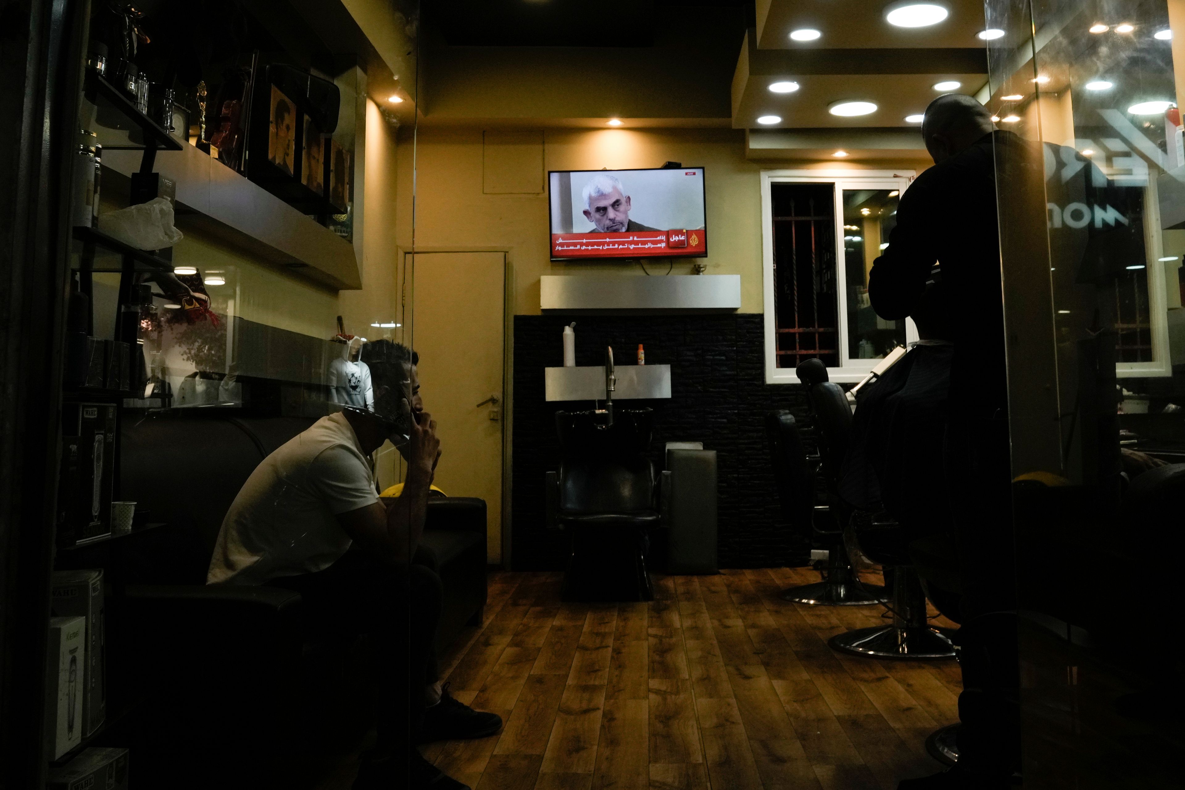 A photo of Hamas Leader Yahya Sinwar is displayed on a TV screen at a barbershop in the West Bank city of Bethlehem, Thursday, Oct 17, 2024. (AP Photo/Mahmoud Illean)