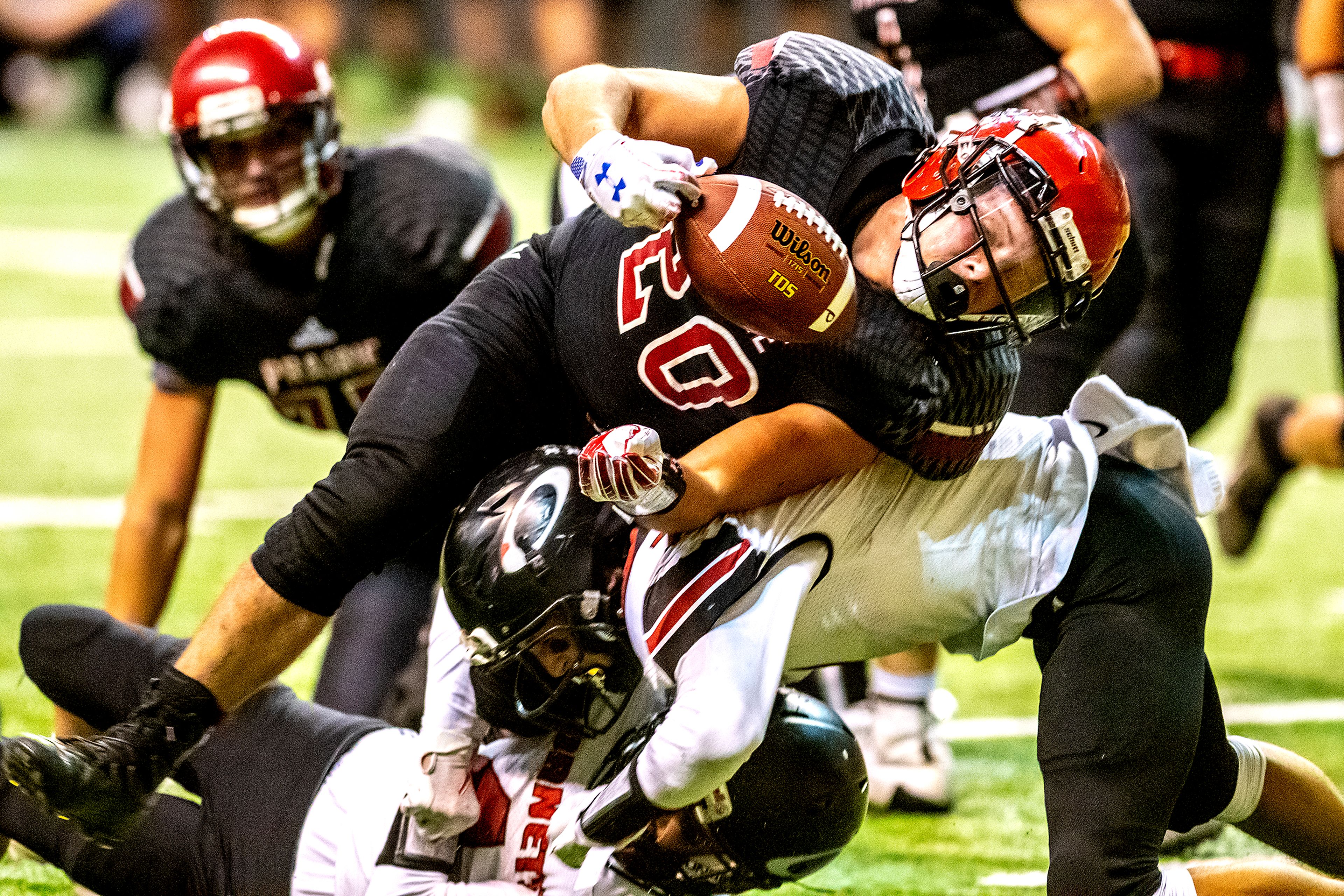 Prairie’s Brody Hasselstrom fumbles the ball after being stopped by Oakley’s Austin Cranney. The Prairie Pirates lost to the Oakley Hornets 42-40 in the Class 1A Division O state semifinal football game at the Kibbie Dome in Moscow on Friday.