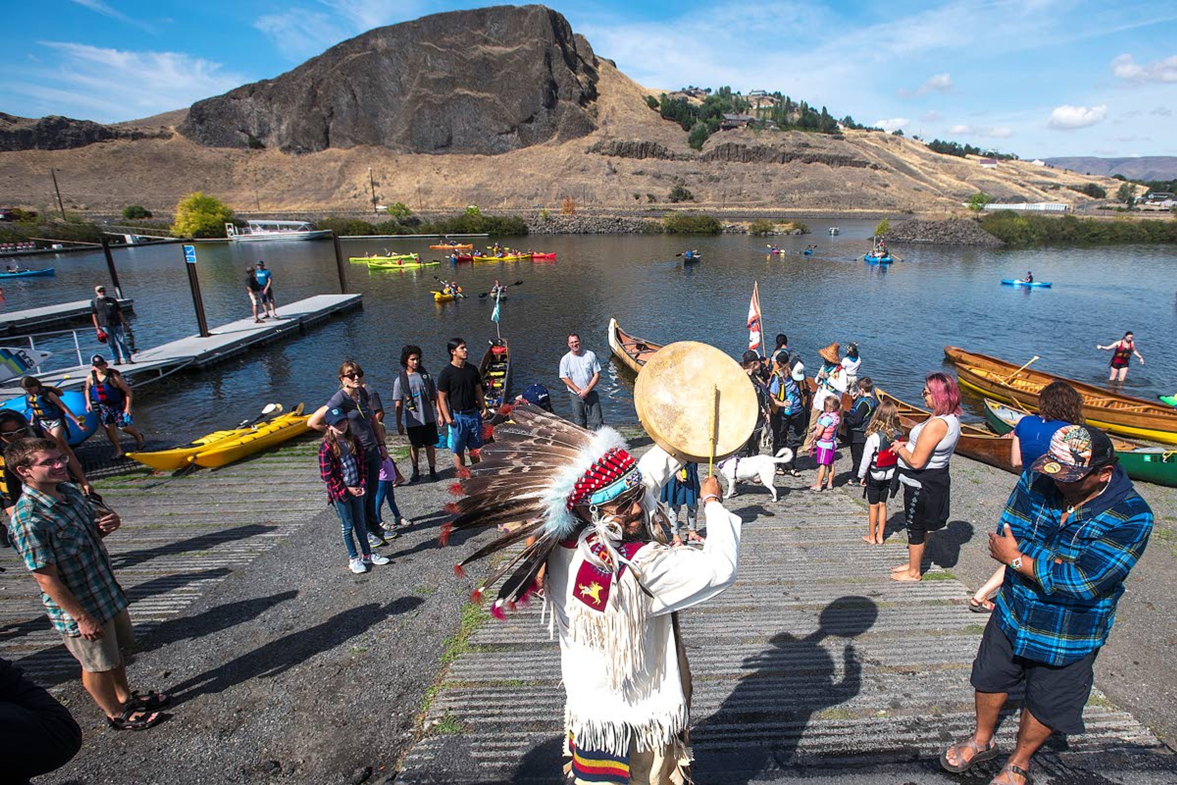 Charleton J.C. Nightwalker, of Tacoma, strikes a drum to corral all of the Nimiipuu River Rendezvous participants after arriving at the Hells Gate State Park Marina on Saturday in Lewiston. The group of nearly 200 people paddled from Asotin to Hells Gate in support of removing the four dams along the lower Snake River.