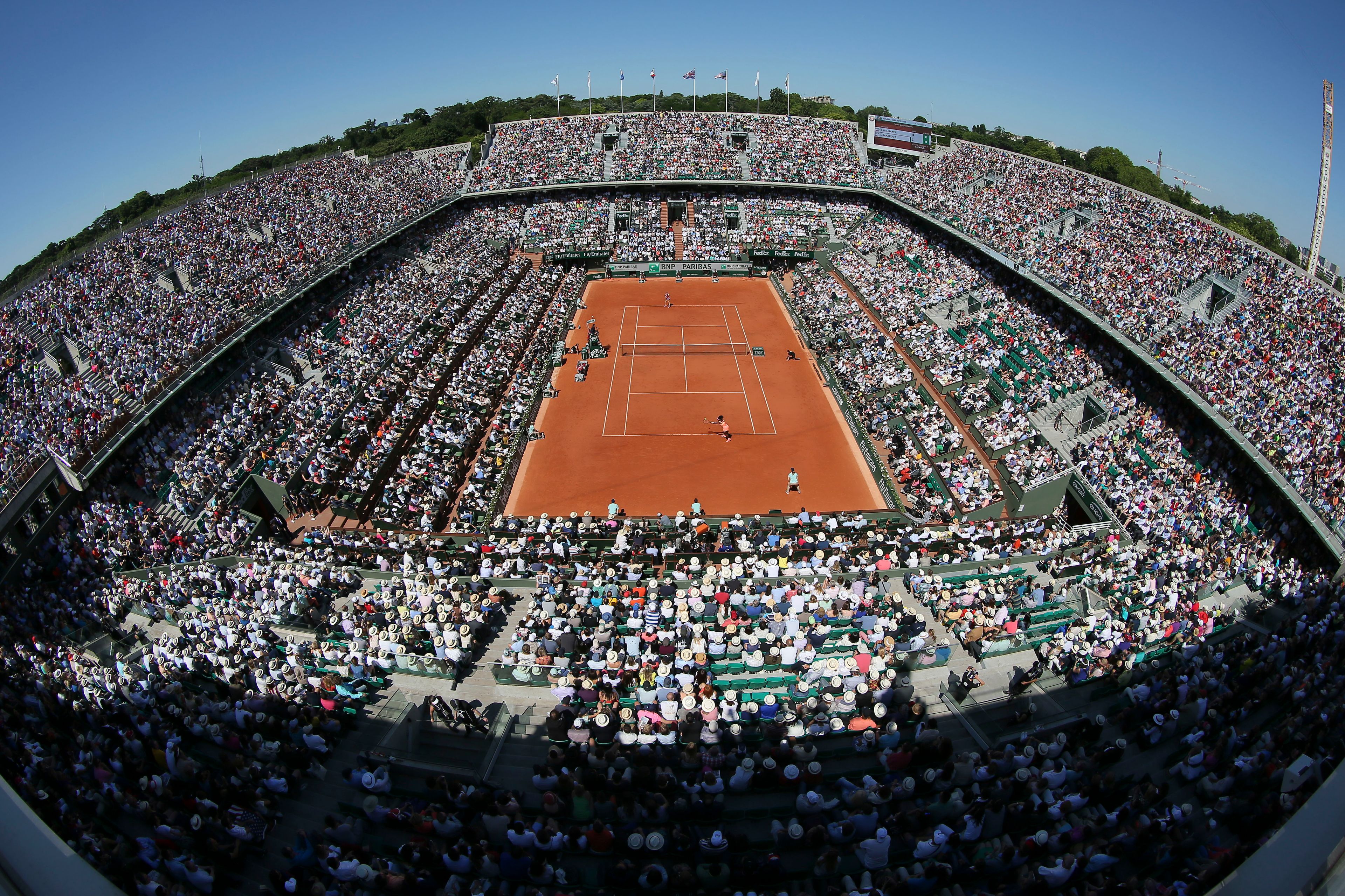 FILE - View of center court with a wide-angle lens as Serena Williams of the U.S., near side, returns in the final of the French Open tennis tournament against Lucie Safarova of the Czech Republic at Roland Garros stadium, in Paris, France, Saturday, June 6, 2015.