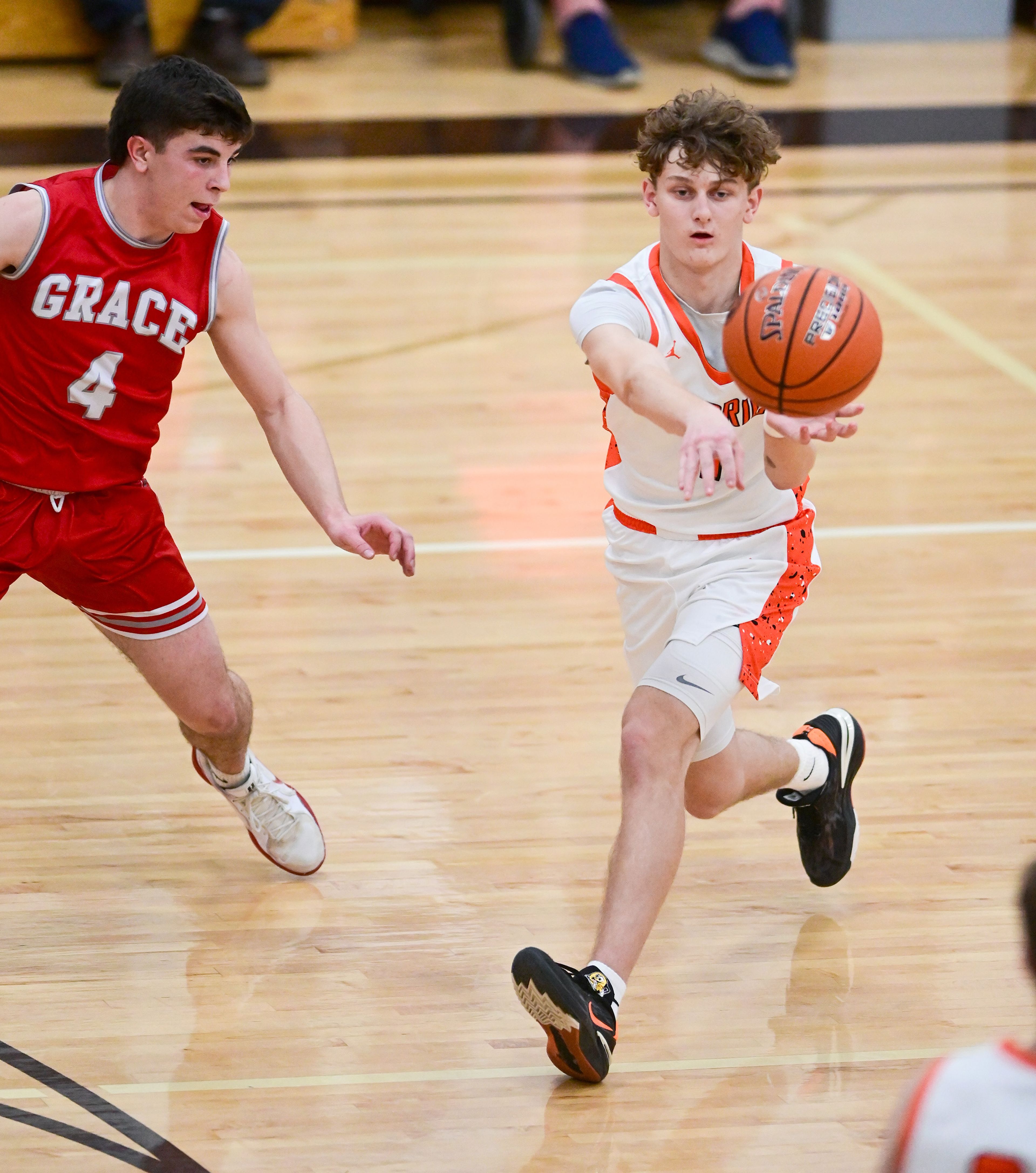 Kendrick's Cade Silflow passes the ball with pressure from Grace's Braden Kimball at the Idaho 2A state tournament on Friday in Caldwell, Idaho.
