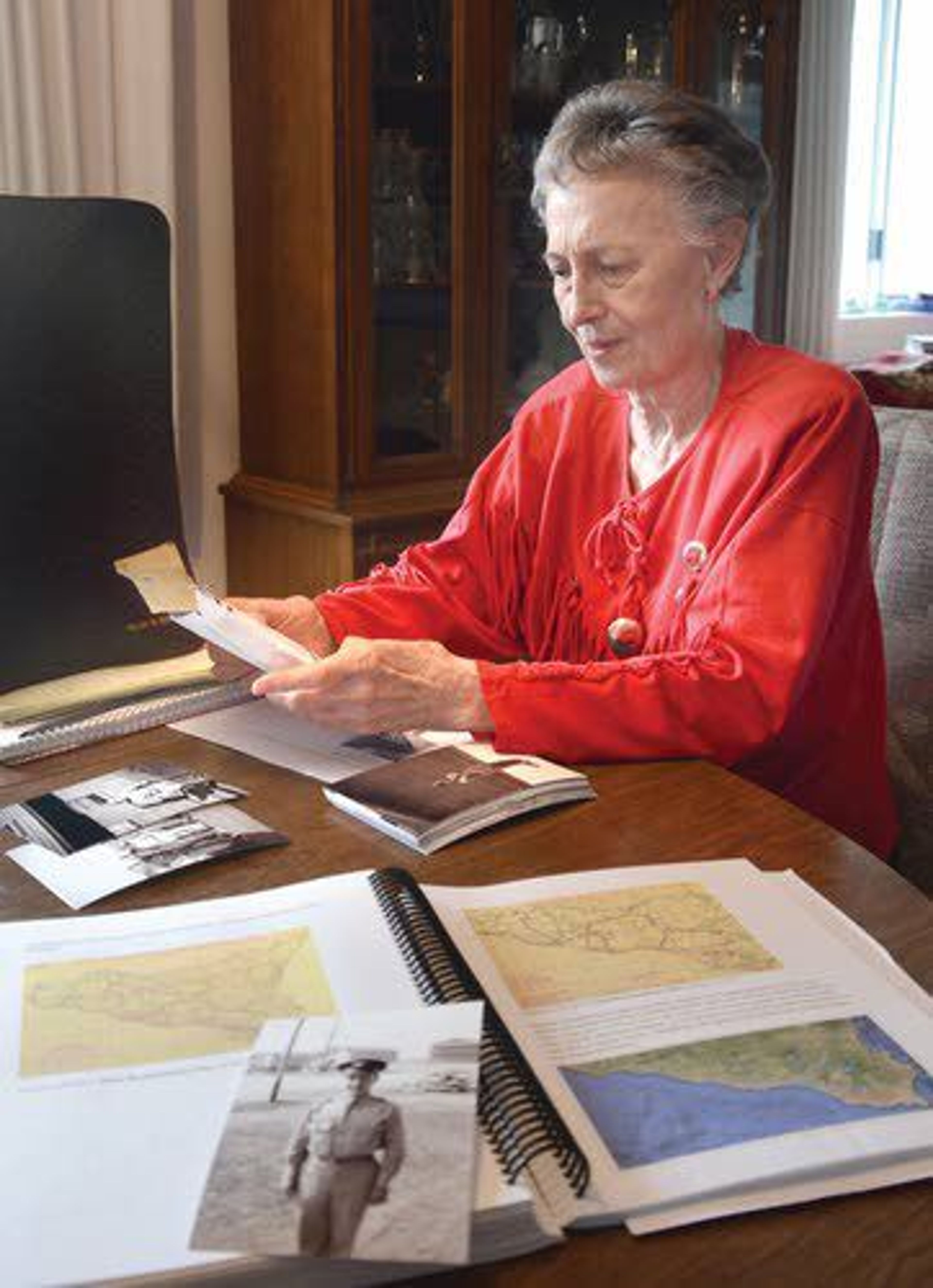 Shirley Finn, of Clarkston, looks through mementos of her brother’s service in World War II in this 2017 Tribune file photo.