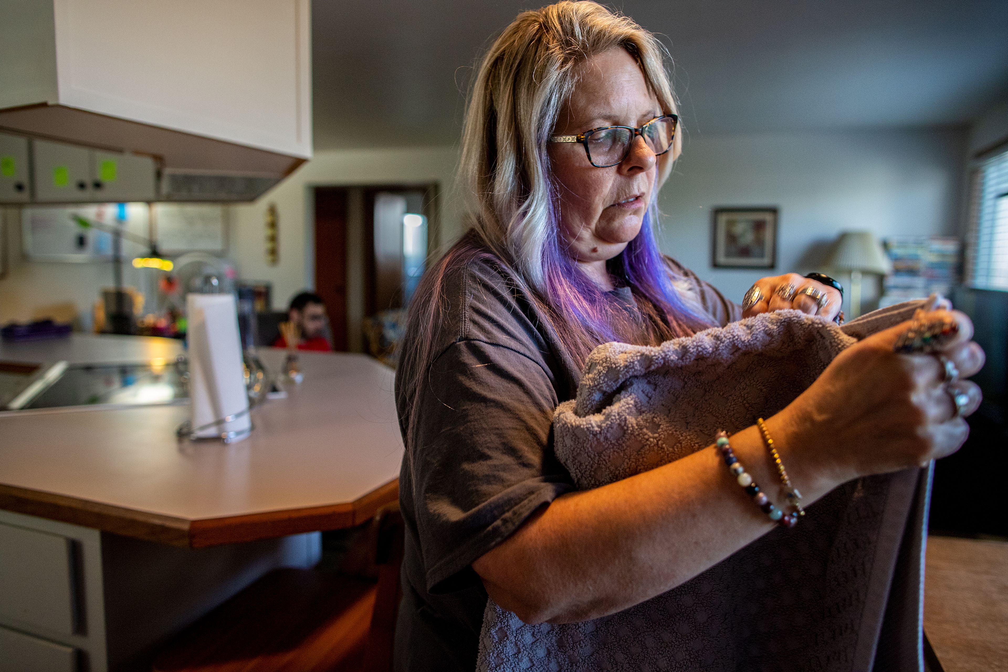 24-Hour House Lead Jill Grant holds some of Kees Beehner’s and his roommates clothing in Beehner’s Opportunities Unlimited Inc. 24-hour residential habilitation supported home in Lewiston on Sept. 21. Beehner shares the apartment with two other intellectually disabled.