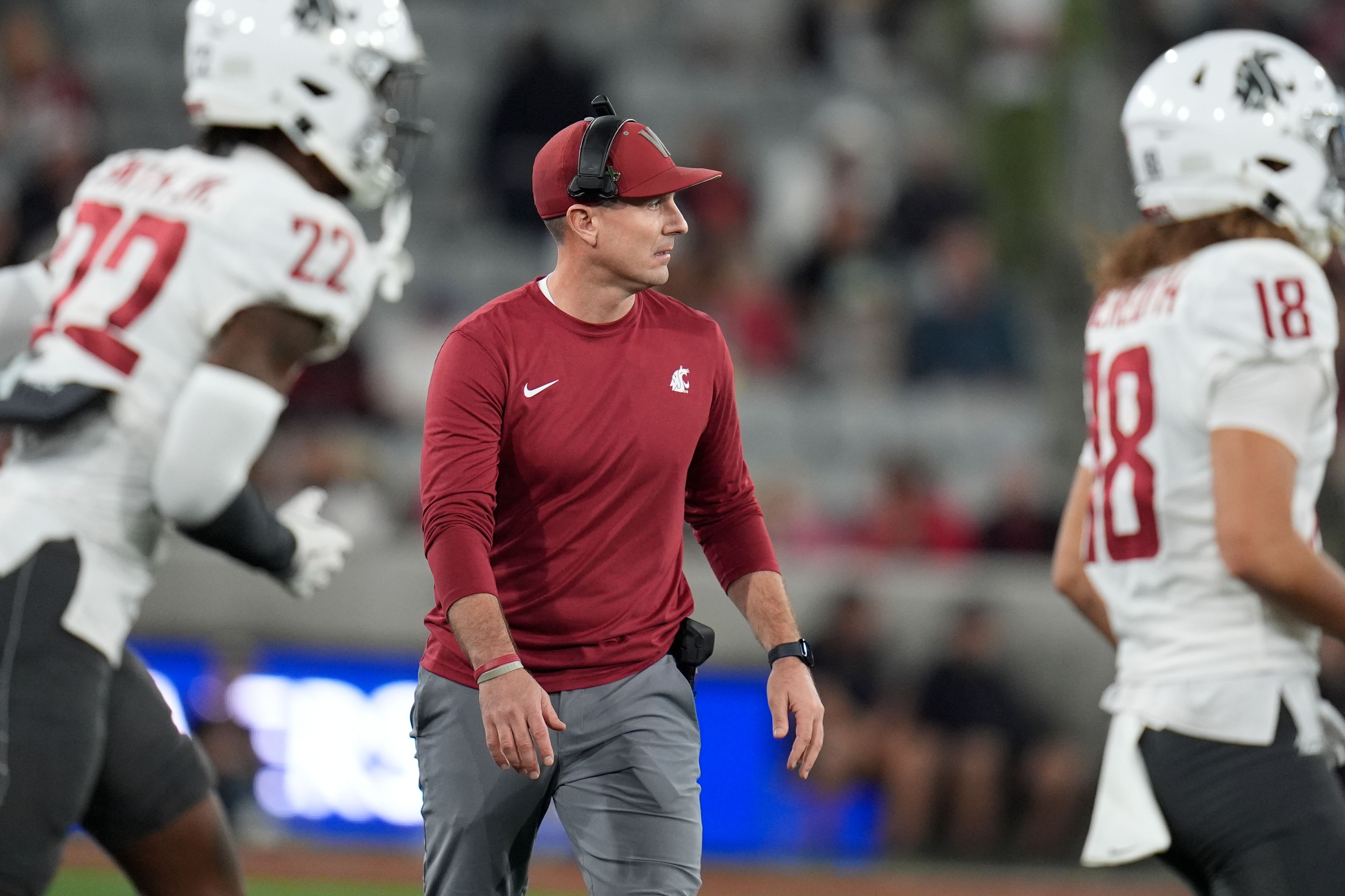 Washington State head coach Jake Dickert, center, looks on during the first half of an NCAA college football game against San Diego State Saturday, Oct. 26, 2024, in San Diego. (AP Photo/Gregory Bull)