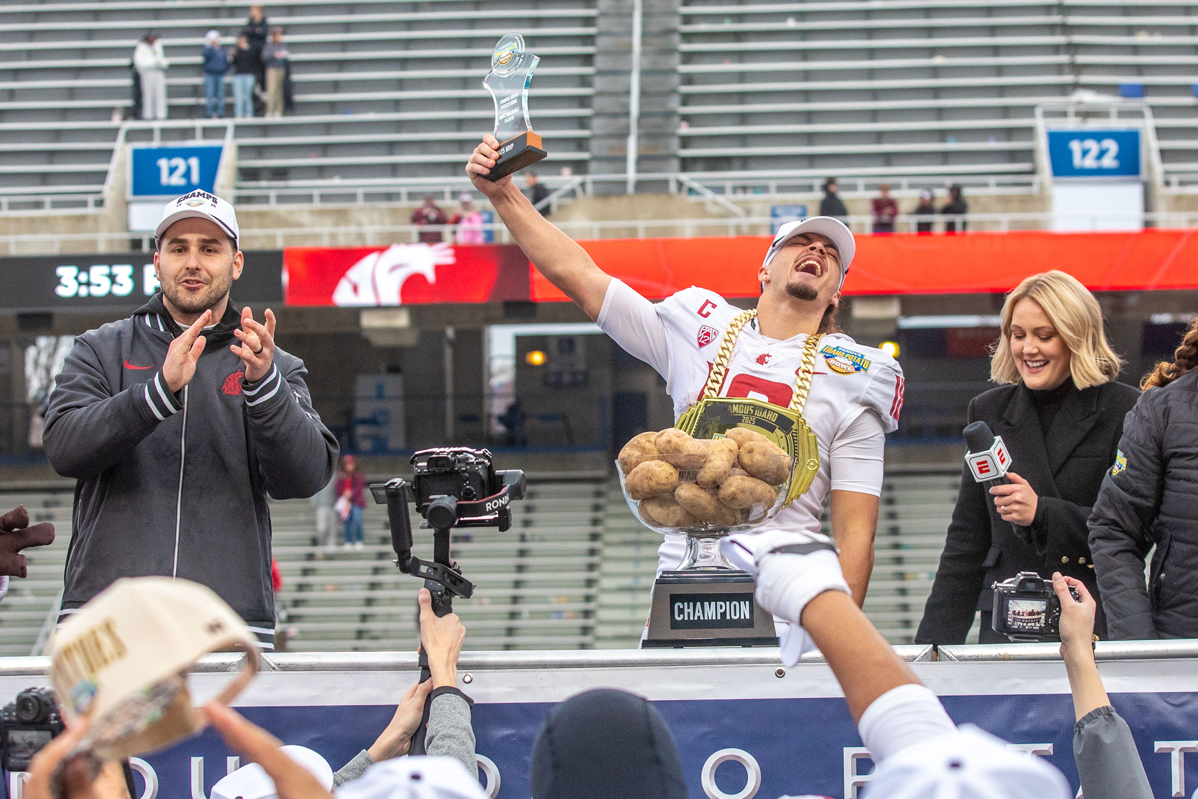 Washington State wide receiver Joshua Meredith is presented with the Most Valuable Player award following the Famous Idaho Potato Bowl on Monday at Albertsons Stadium in Boise. Washington State defeated Utah State 34-21.