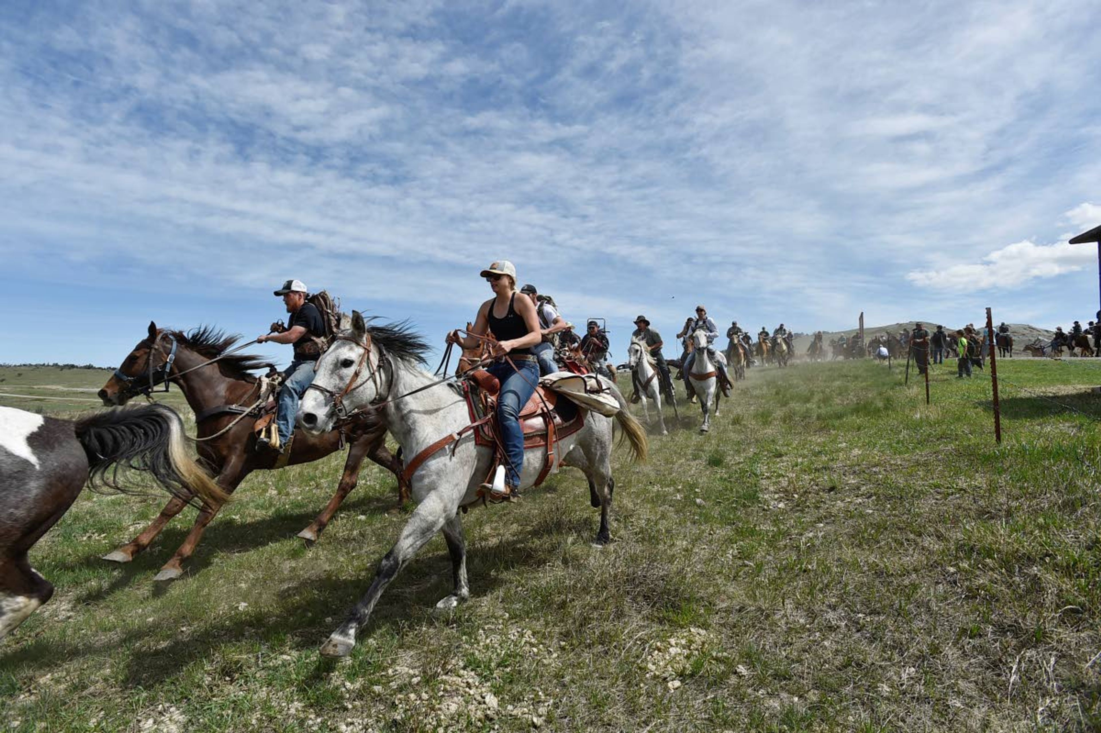 Horse riders race onto the Sun River Wildlife Managmement Area at noon May 15 for the annual opening day of shed hunting at the Montana refuge, where thousands of elk winter and bulls drop their antlers.