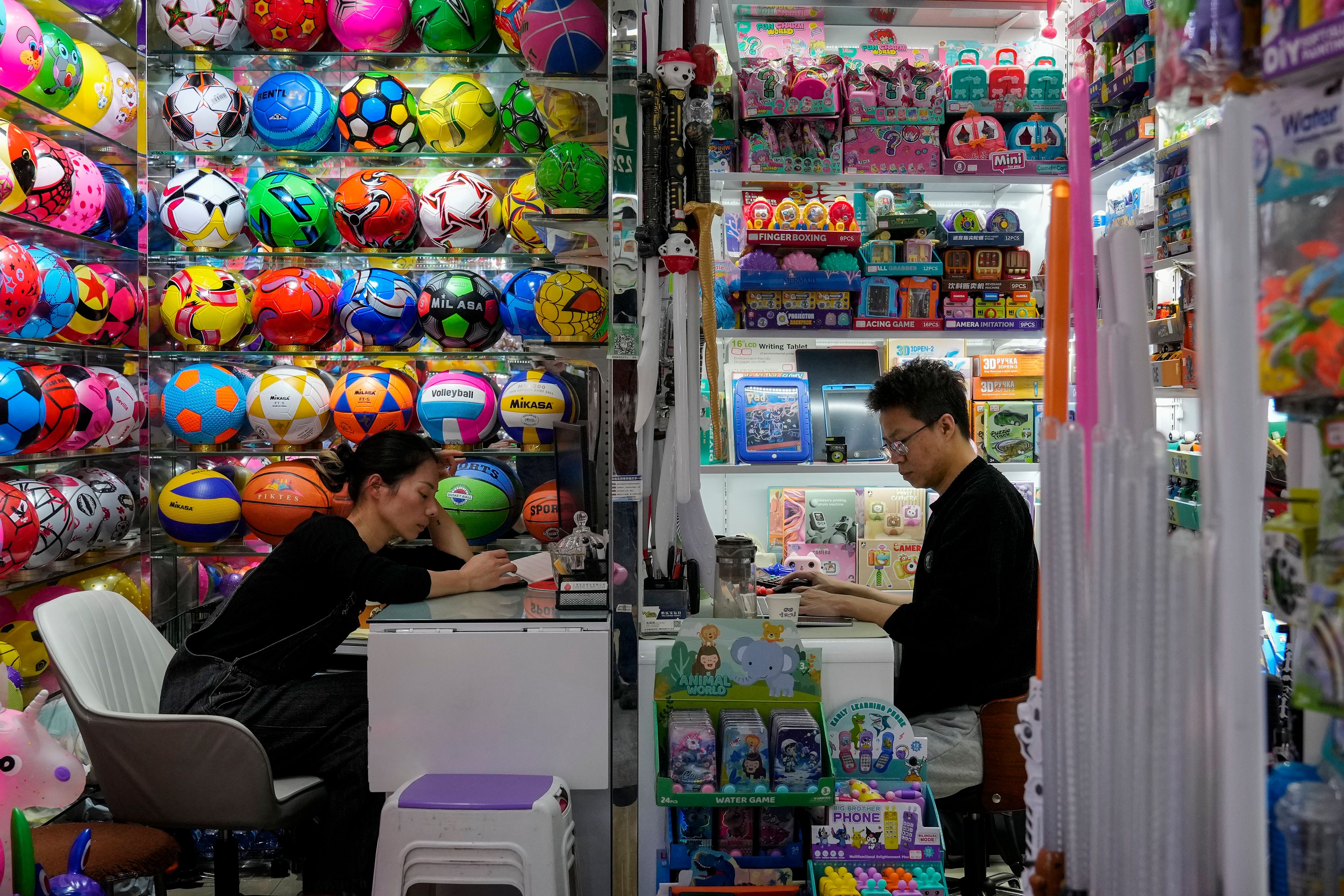 Vendors wait for customers at their stores selling variety toys at the Yiwu wholesale market in Yiwu, east China's Zhejiang province on Nov. 8, 2024. (AP Photo/Andy Wong)