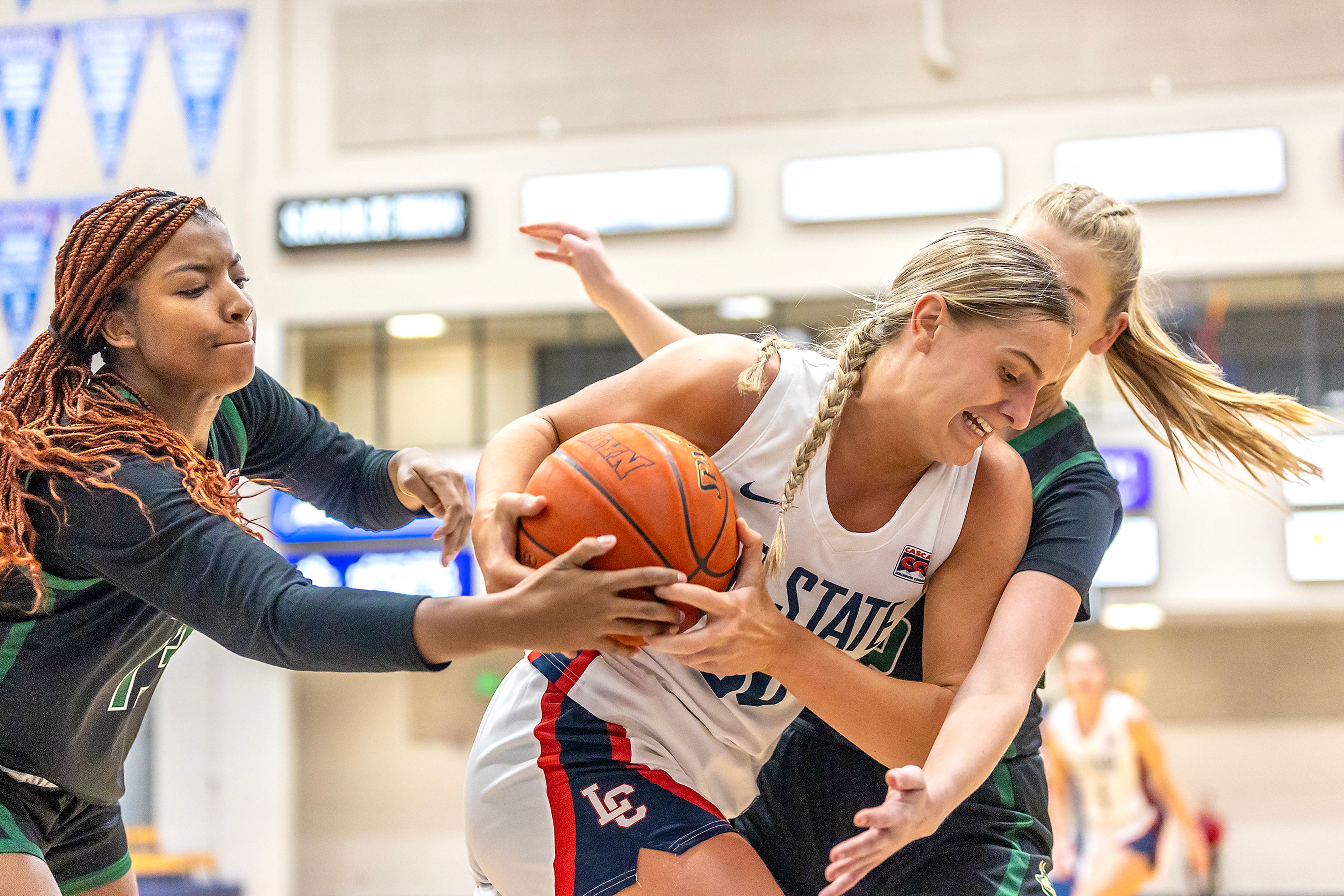 Lewis-Clark State forward Darian Herring keeps the ball out of the hands of Walla Walla forward Jordan Green-Wallace during a quarter of a Cascade Conference game Tuesday at Lewis-Clark State College in Lewiston.