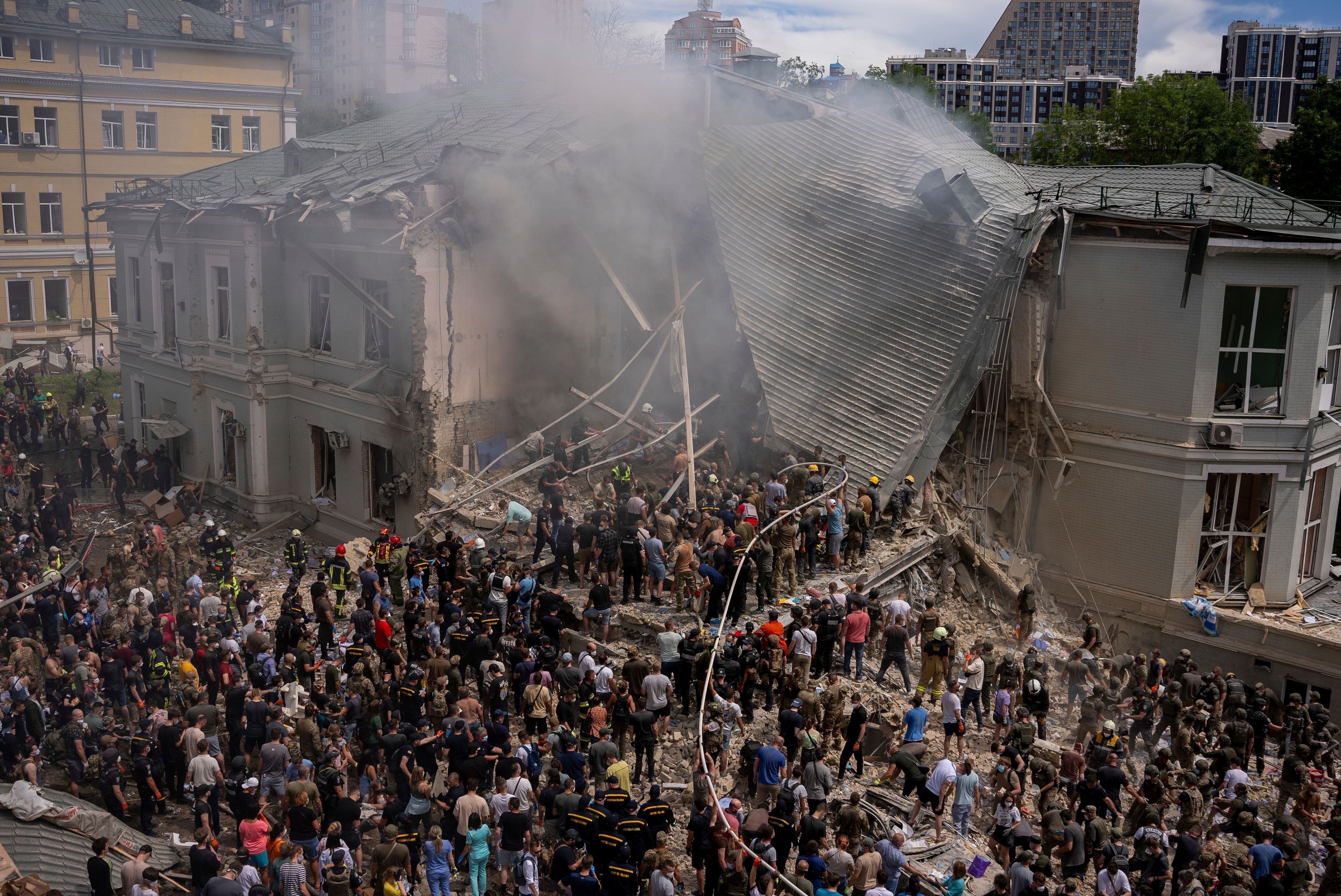 Emergency workers respond at the Okhmatdyt children's hospital hit by Russian missiles, in Kyiv, Ukraine, Monday, July 8, 2024. A major Russian missile attack across Ukraine on Monday killed at least 31 people and injured 154, officials said, with one striking a large childrenâ€™s hospital in the capital of Kyiv, where emergency crews searched the rubble for victims. (AP Photo/Alex Babenko)