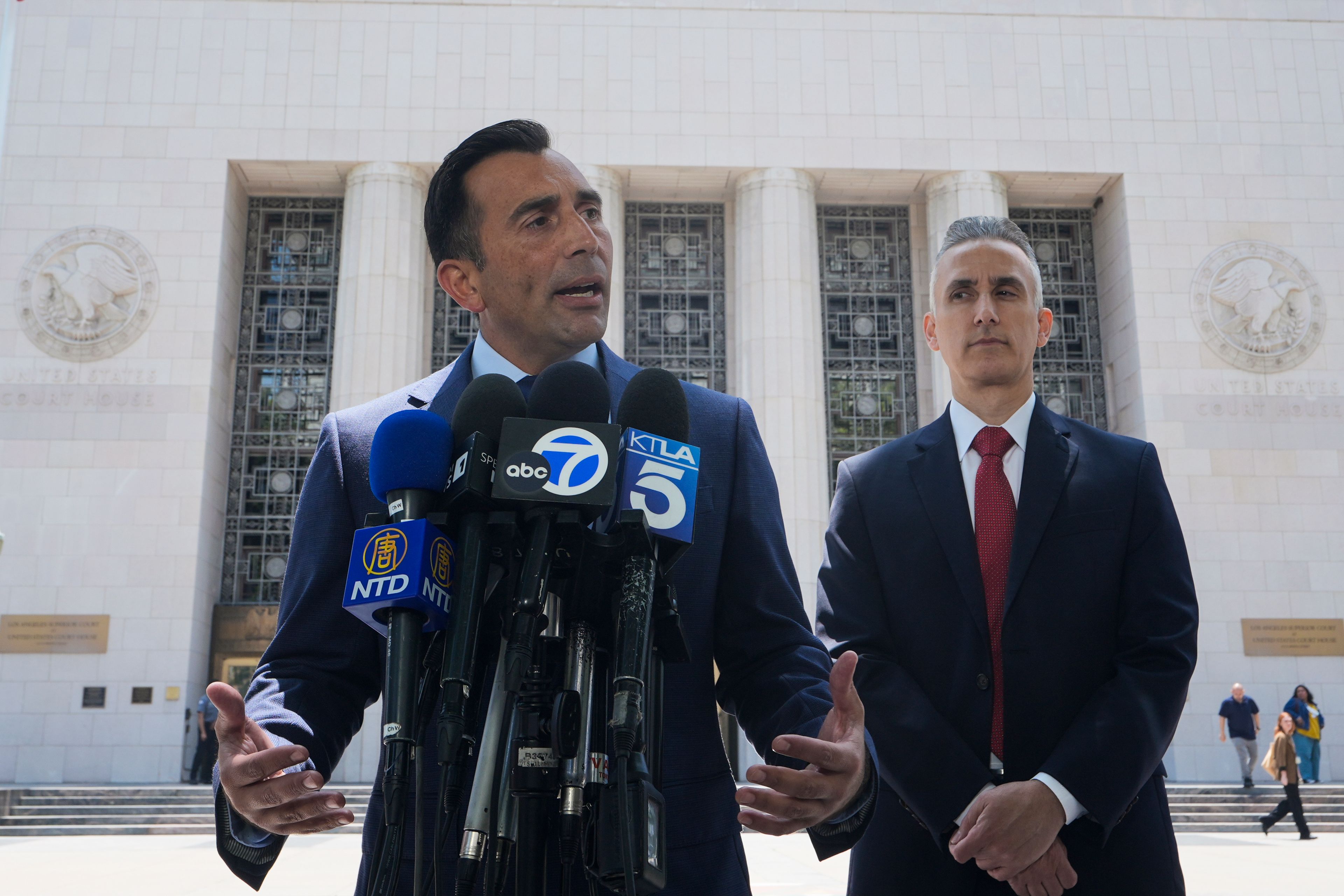 U.S. Attorney Martin Estrada, center, speaks as federal prosecutor Jeff Mitchell, listens at right, during a news conference in Los Angeles Tuesday, June 4, 2024. Ippei Mizuhara, the former interpreter for Los Angeles Dodgers star Shohei Ohtani, pleaded guilty to bank and tax fraud on Tuesday and admitted to stealing nearly $17 million from the Japanese baseball player to pay off sports betting debts.