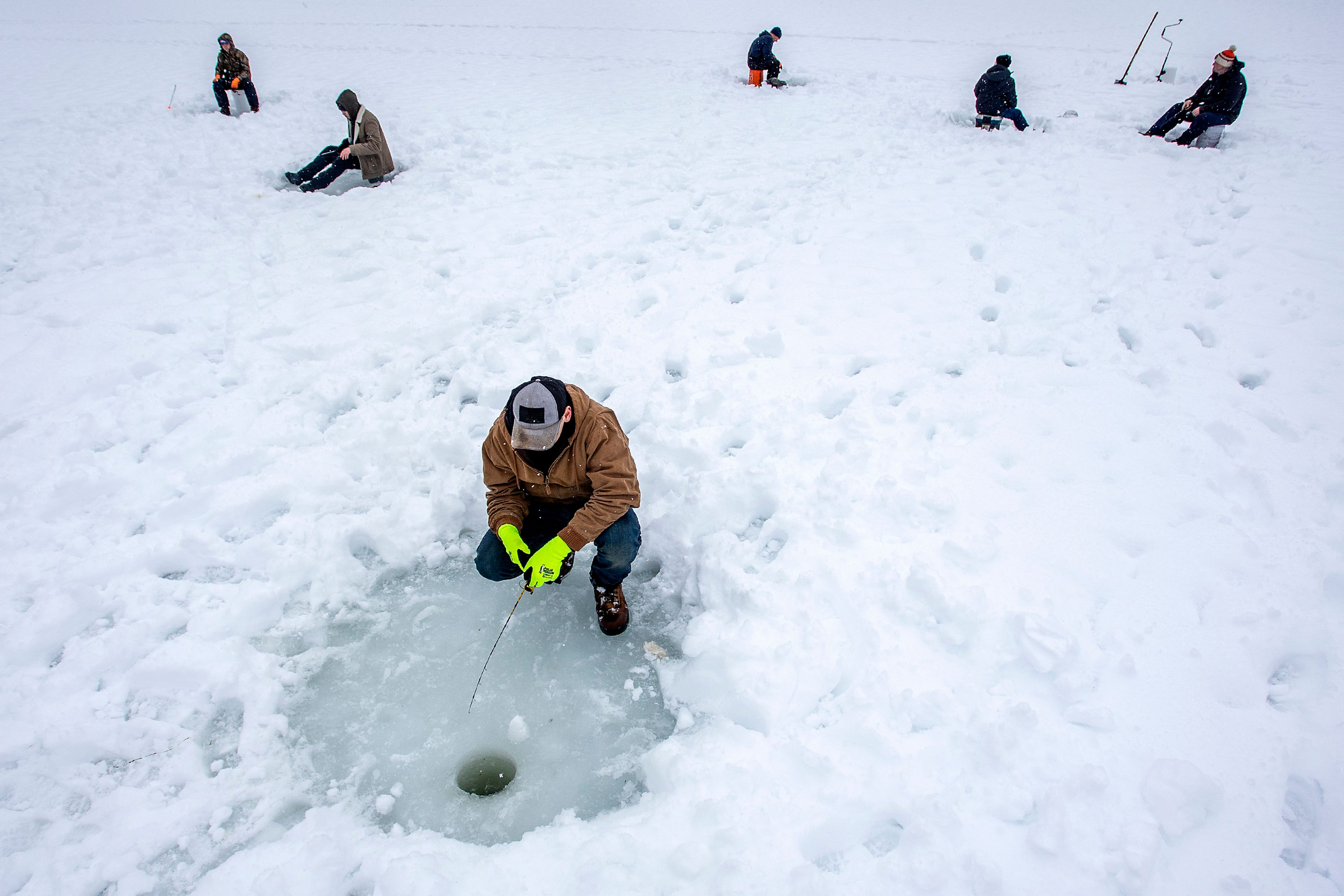 Jacob Brewster, of Harrison, waits for a bite on his hook while ice fishing on the Elk Creek Reservoir during the Elk River Ice Fishing Derby on Saturday, Feb. 6, 2021