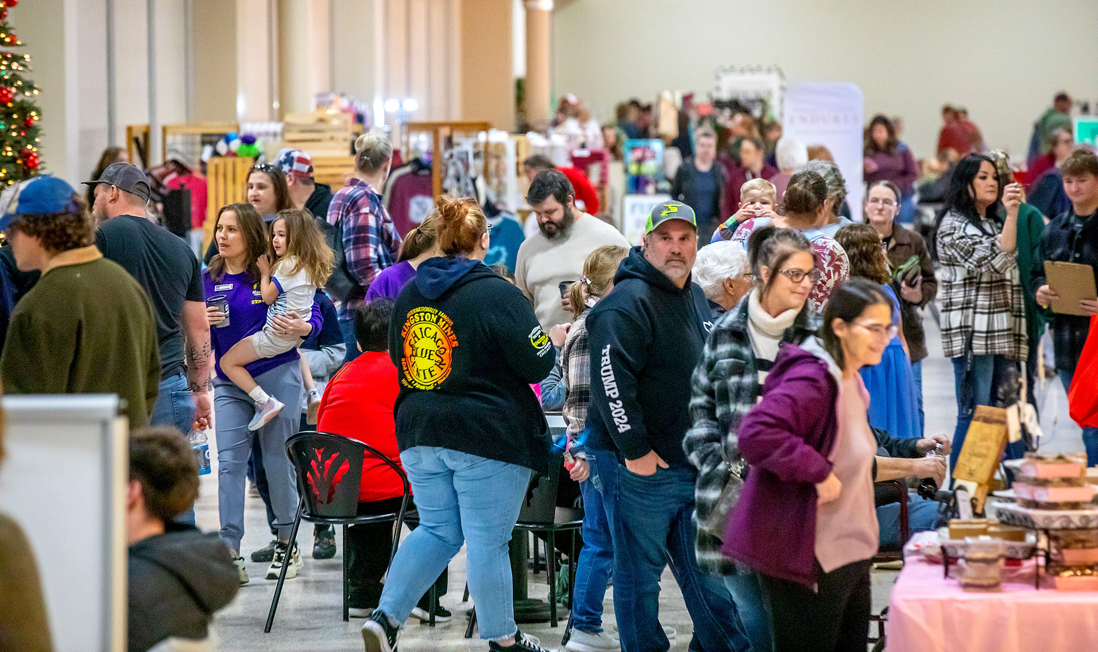 People walk around shopping at the Lewiston Center Mall Christmas Market on Friday.