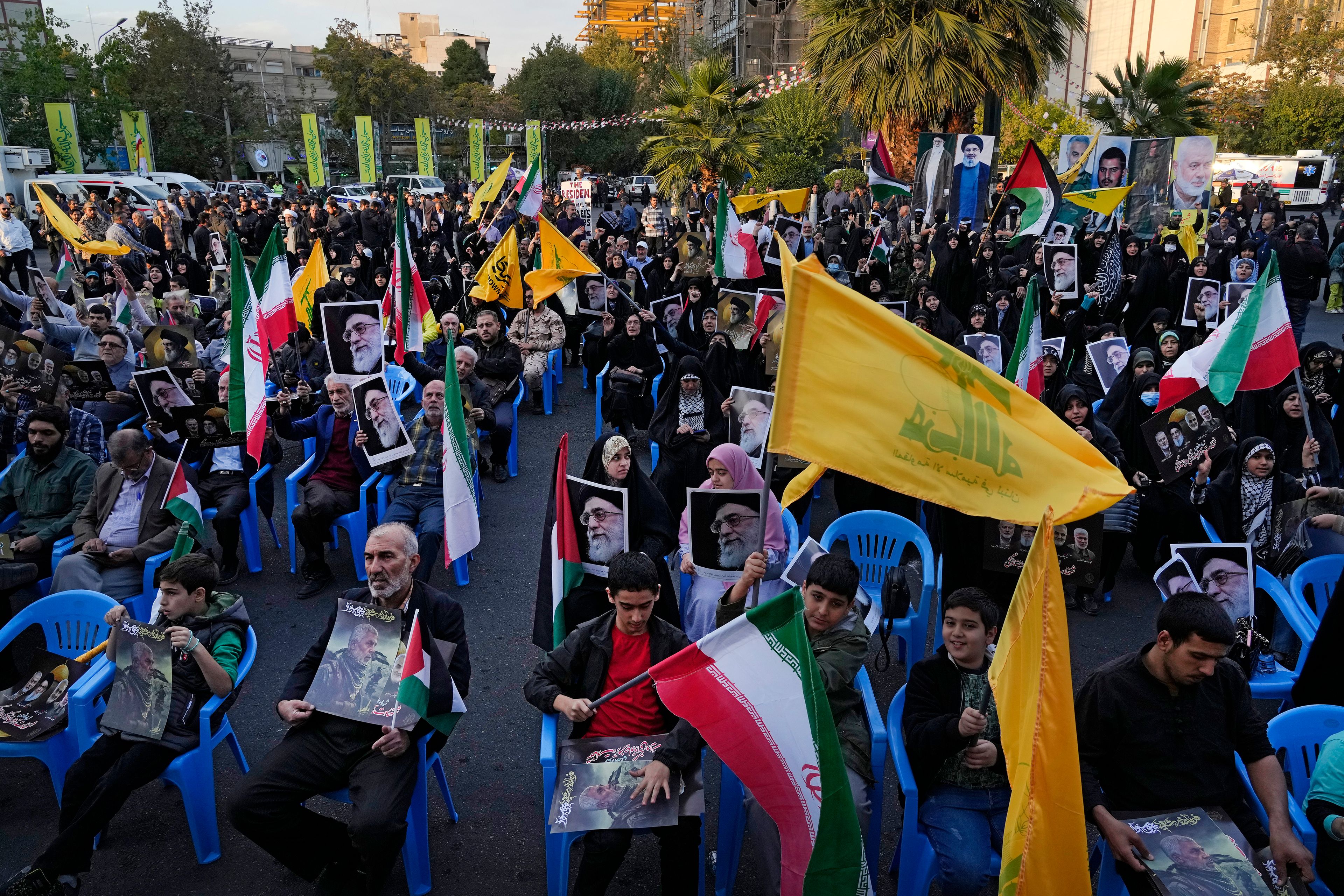 Iranian demonstrators attend a ceremony commemorating the late Hamas leader Yahya Sinwar and Hashem Safieddine, a powerful cleric who was expected to succeed slain Hezbollah leader Hassan Nasrallah and was killed by an Israeli airstrike in Beirut, at the Felestin (Palestine) Sq. in Tehran, Iran, Thursday, Oct. 24, 2024. (AP Photo/Vahid Salemi)