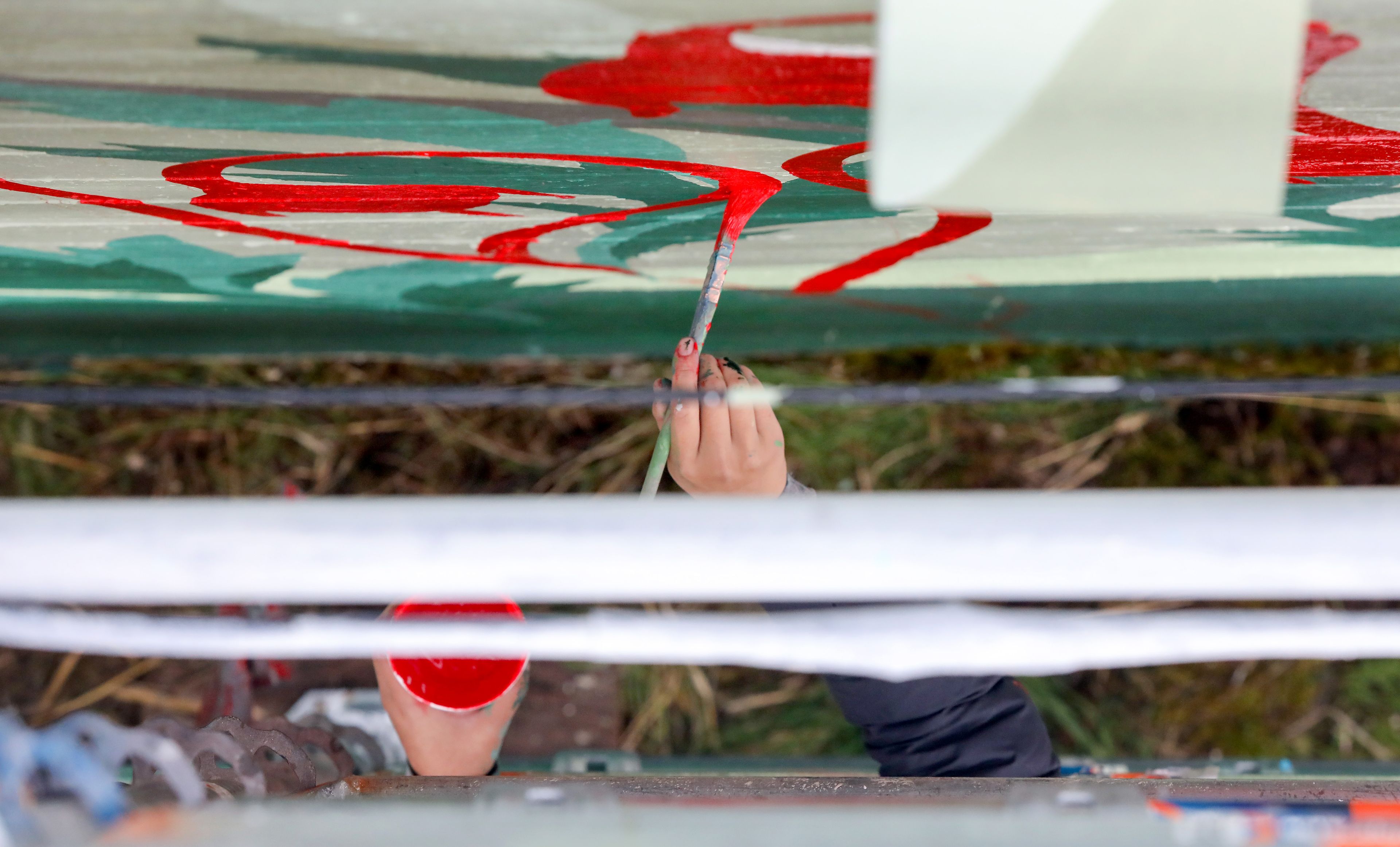 Tori Shao, an artist and landscape architect, works on a new mural in downtown Pullman.