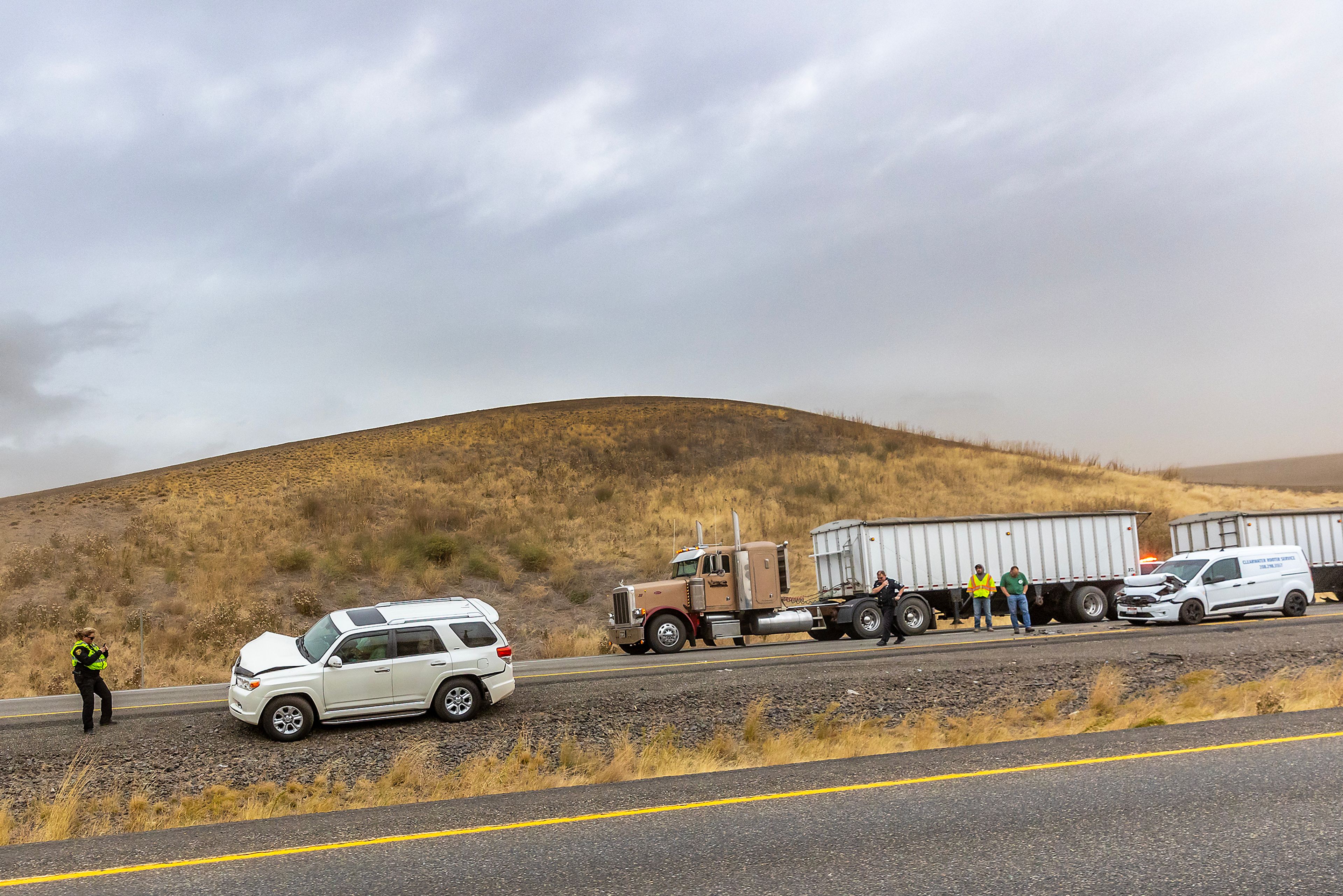 Police respond to a multiple wrecked cars in the southbound lane of U.S. Highway 95 as heavy wind blows dust across the region Friday.