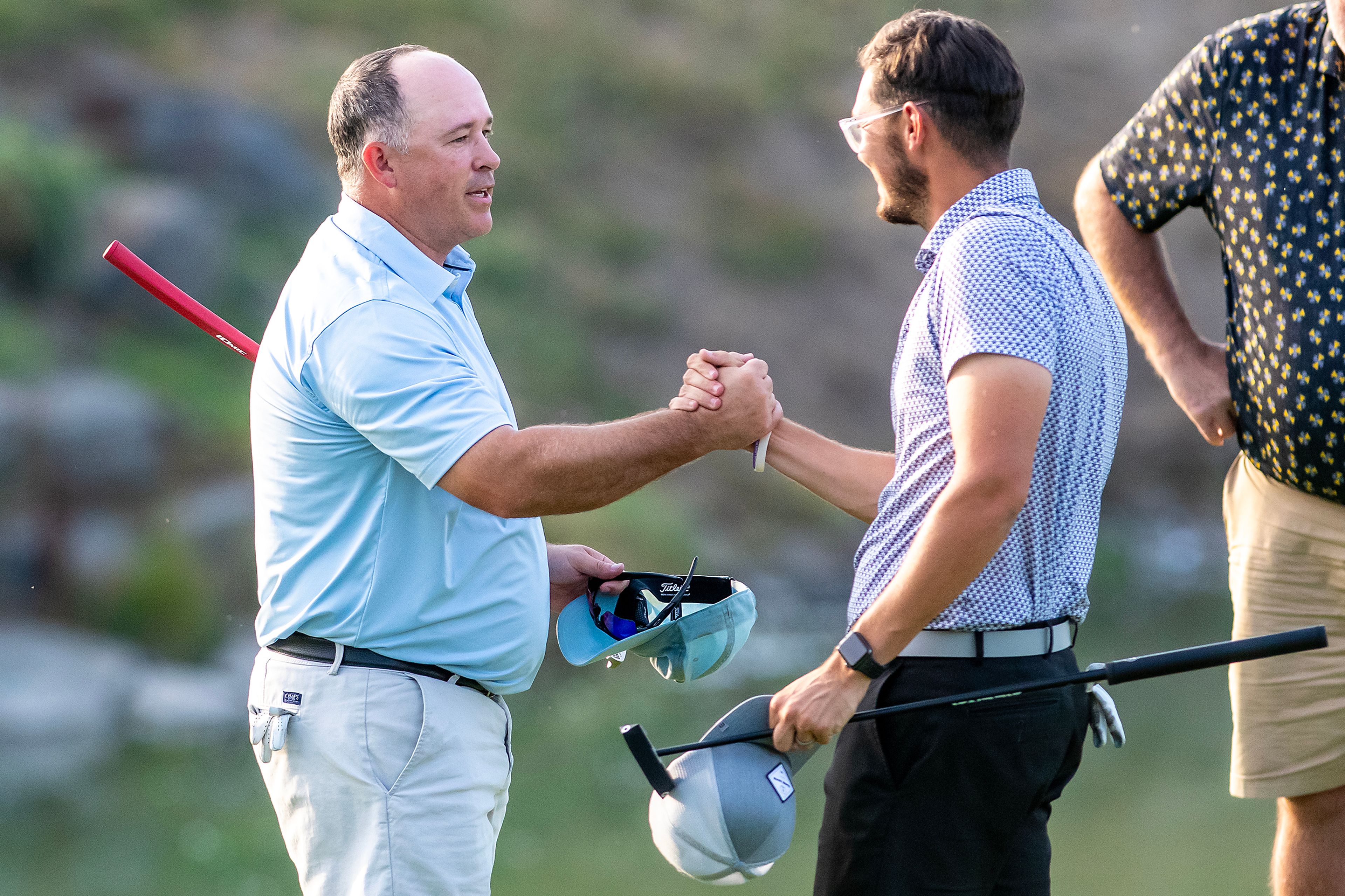 Jason Huff (left) shakes hands with second-place Zach Anderson after his victory in the Sole Survivor Tournament Monday at the Lewiston Golf and Country Club.