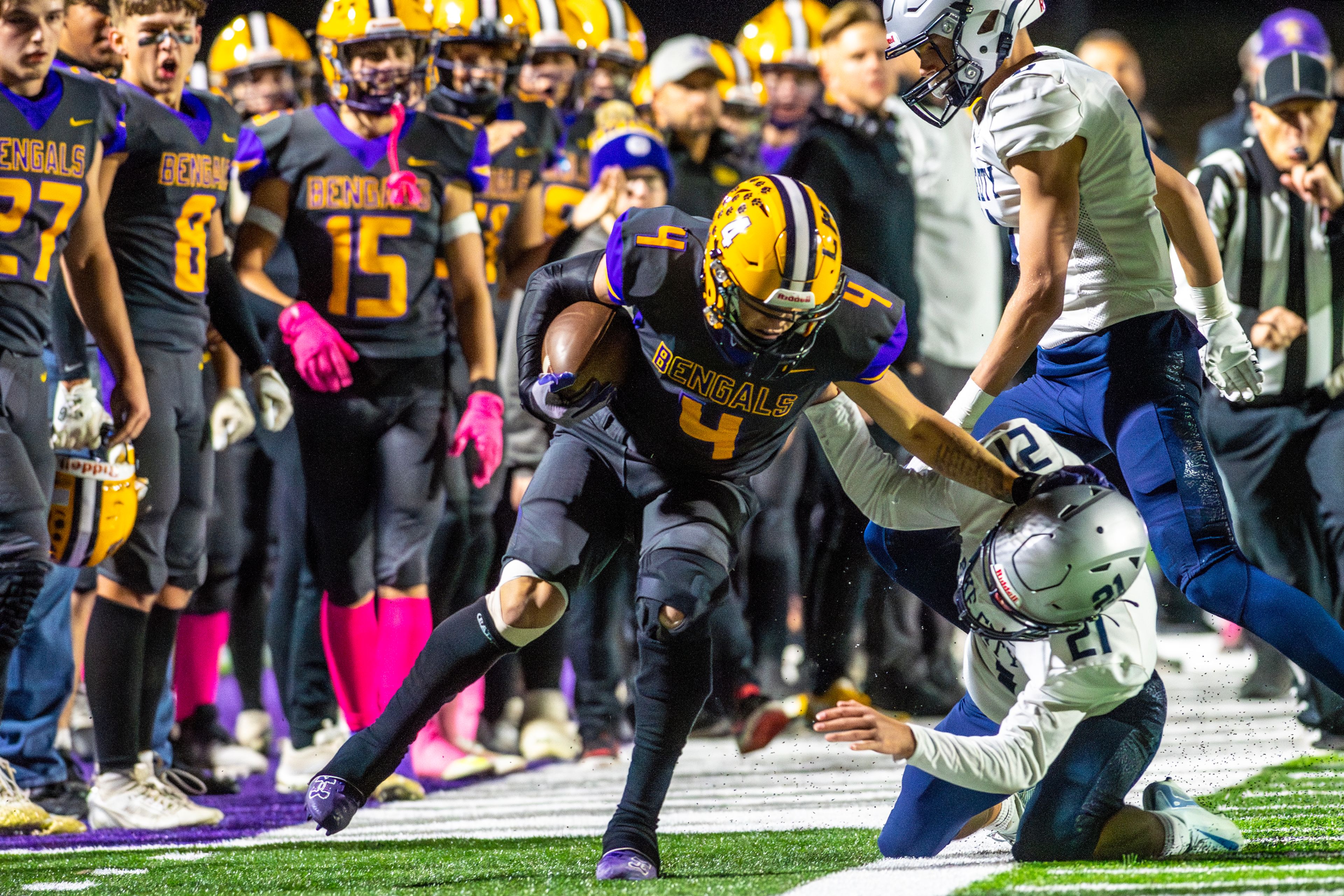 Lewiston running back Noah Carpenter stiff arms Lake City defensive back Alden Curto as he�s pushed out of bounds in a nonconference game Friday at Lewiston High School.,