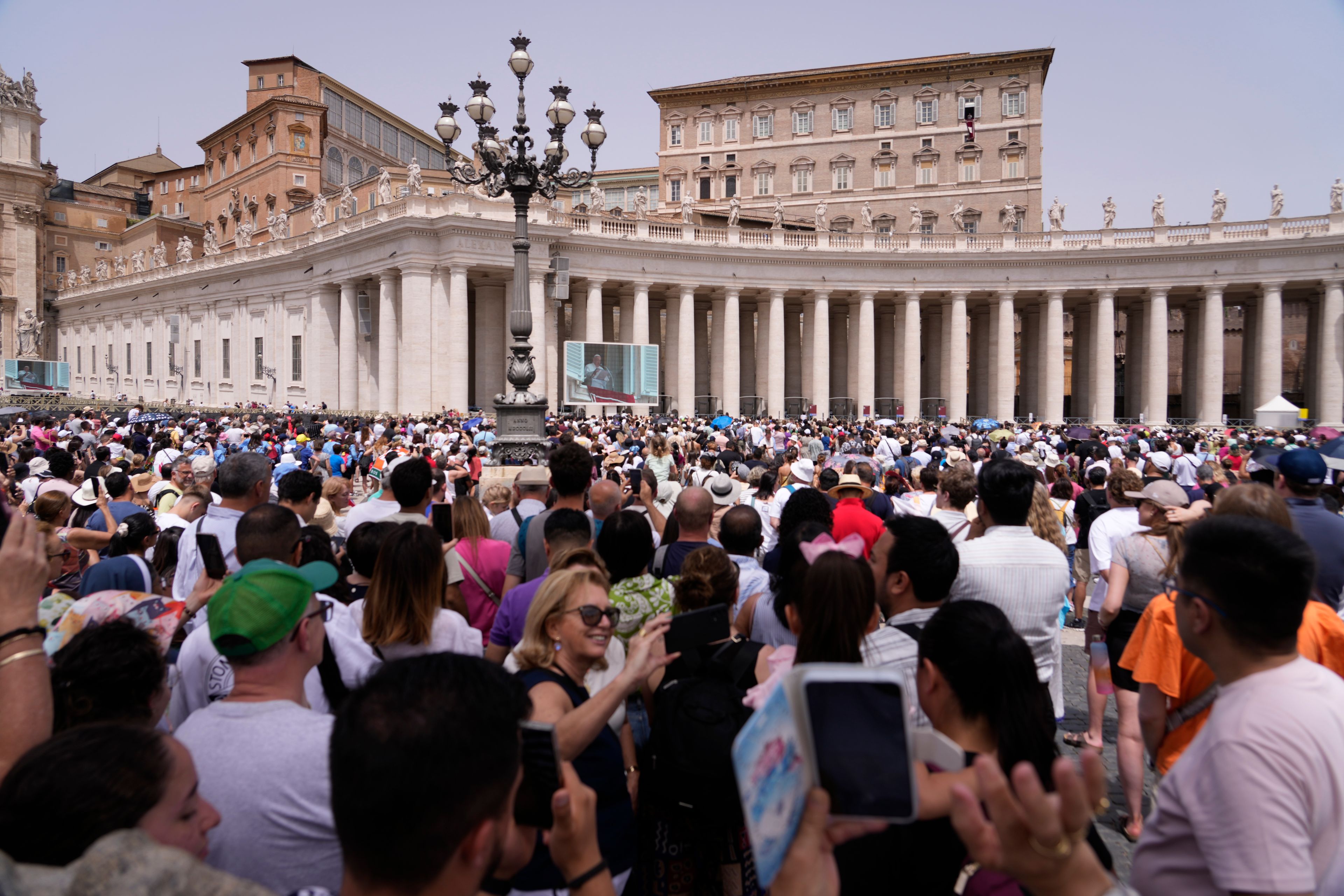 Pope Francis appears at his studiio's window overlooking St. Peter's Square at The Vatican, Sunday, June 9, 2024, where faithful and pilgrims gathered for the traditional Sunday's blessing at the end of the Angelus prayer.