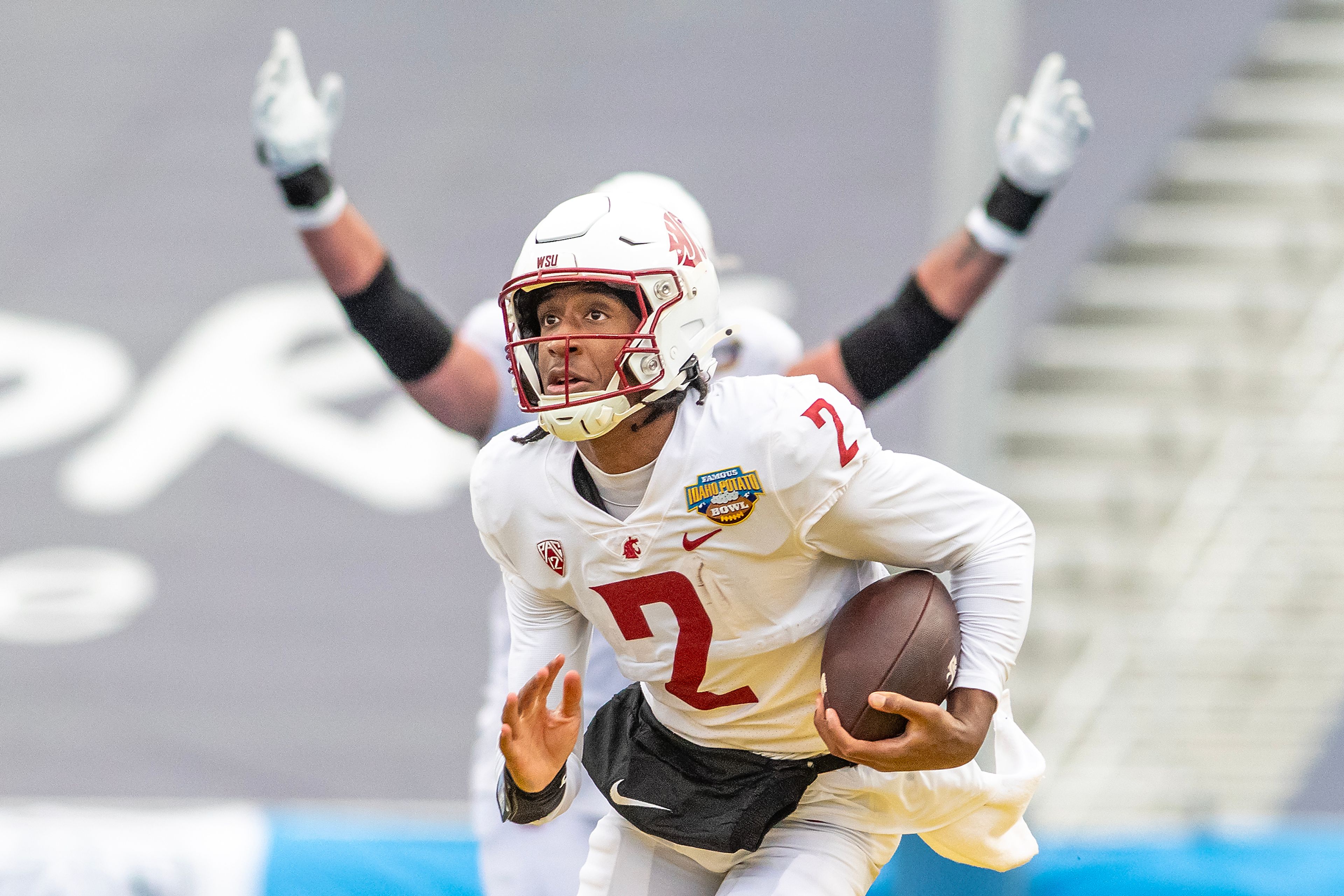Washington State quarterback Julian Dugger runs the ball in for a touchdown against Utah State during the Famous Idaho Potato Bowl on Dec. 22 at Albertsons Stadium in Boise. Washington State defeated Utah State 34-21.