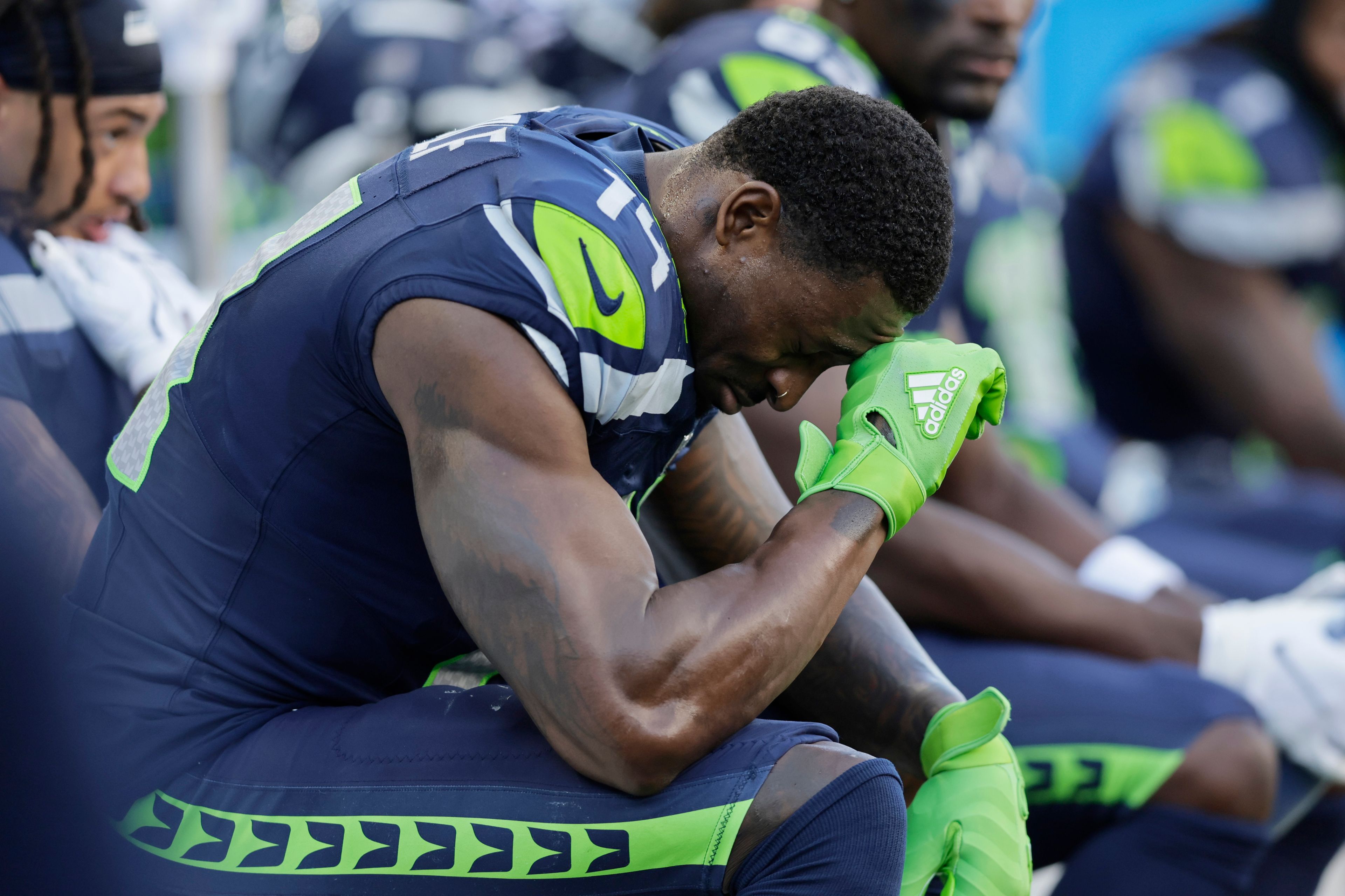 Seattle Seahawks wide receiver DK Metcalf (14) sits on the sideline during the second half of an NFL football game against the New York Giants, Sunday, Oct. 6, 2024, in Seattle. (AP Photo/John Froschauer)