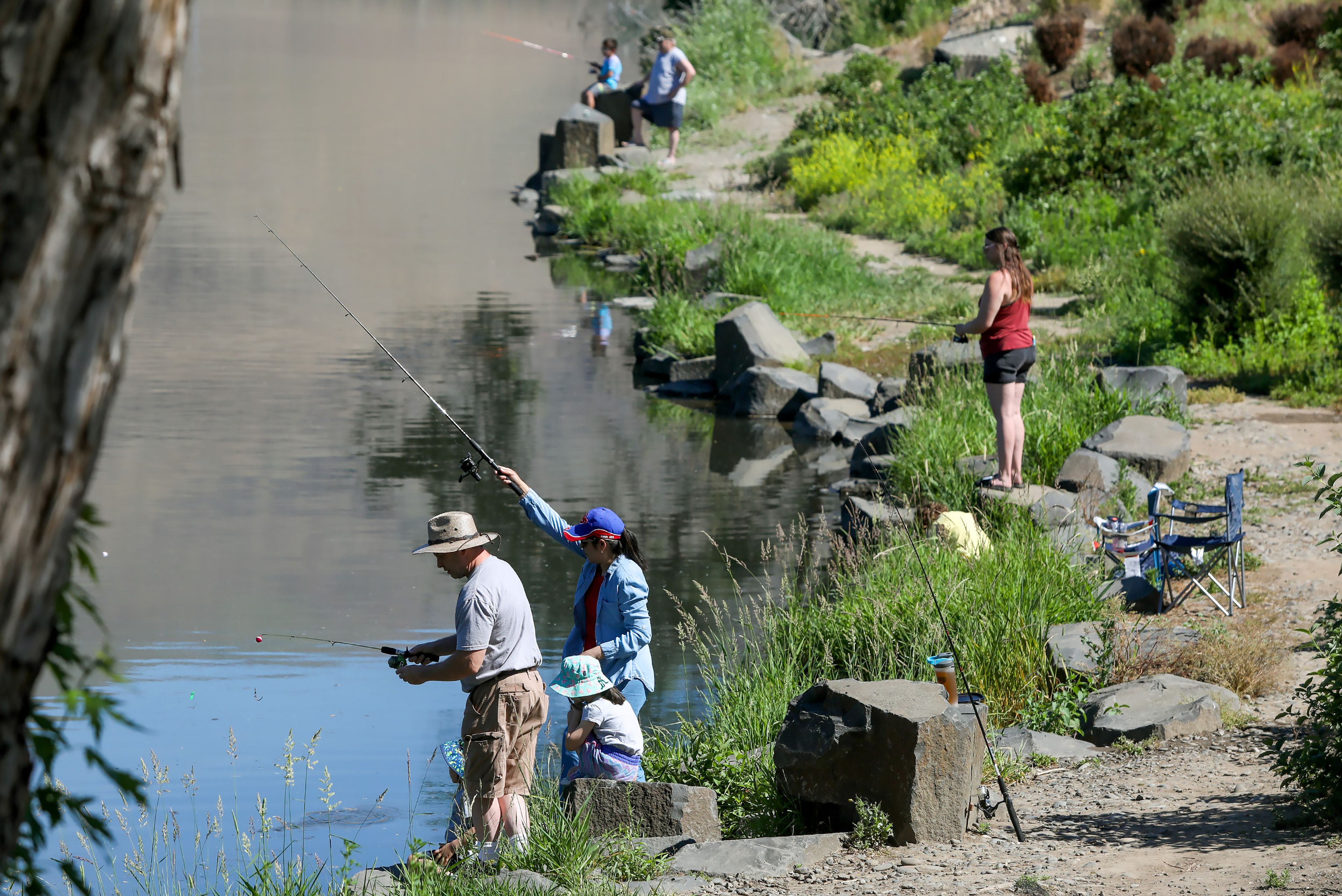 Community members from Lewiston and Clarkston, including the O’Callaghan family, front, take part in Idaho's Free Fishing Day at Kiwanis Park Pond on Saturday in Lewiston.