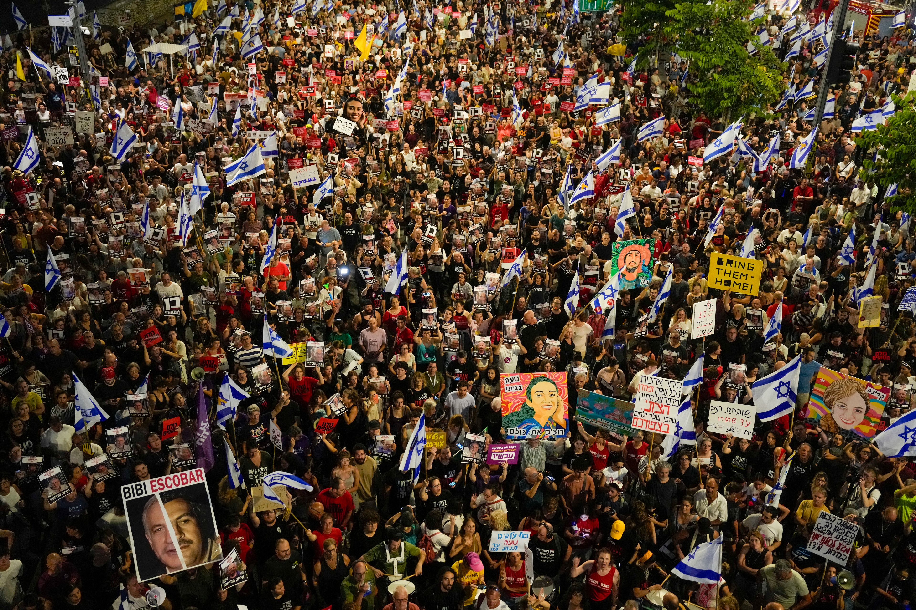 People protest against Israeli Prime Minister Benjamin Netanyahu's government and call for the release of hostages held in the Gaza Strip by the Hamas militant group, in Tel Aviv, Israel, Saturday, June 8, 2024. Israel said Saturday it rescued four hostages who were kidnapped in the Hamas-led attack on Oct. 7, the largest such recovery operation since the war began in Gaza.