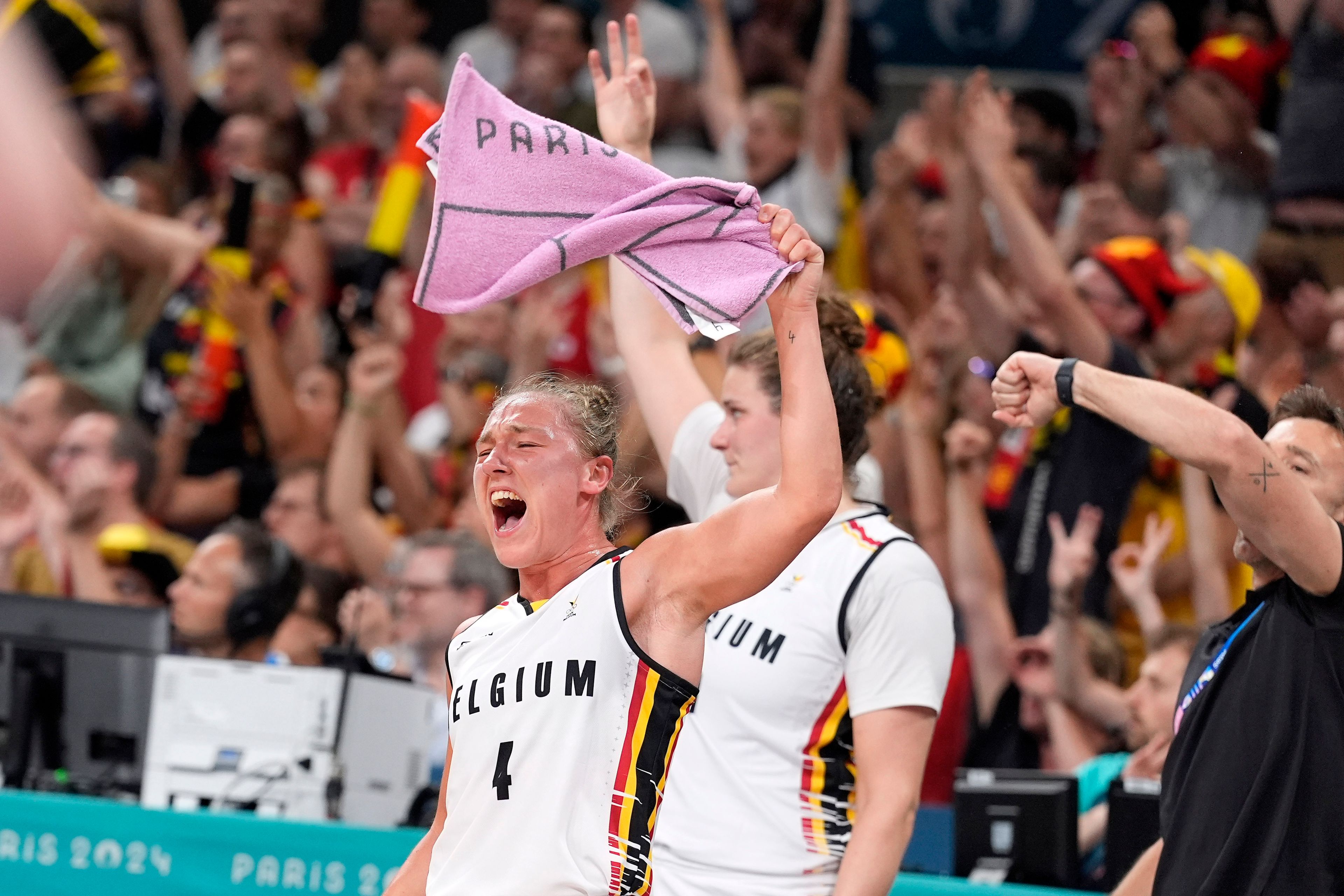 Belgium's Elisa Ramette celebrates from the bench after the scored during a women's basketball game against the United States at the 2024 Summer Olympics, Thursday, Aug. 1, 2024, in Villeneuve-d'Ascq, France. (AP Photo/Michael Conroy)