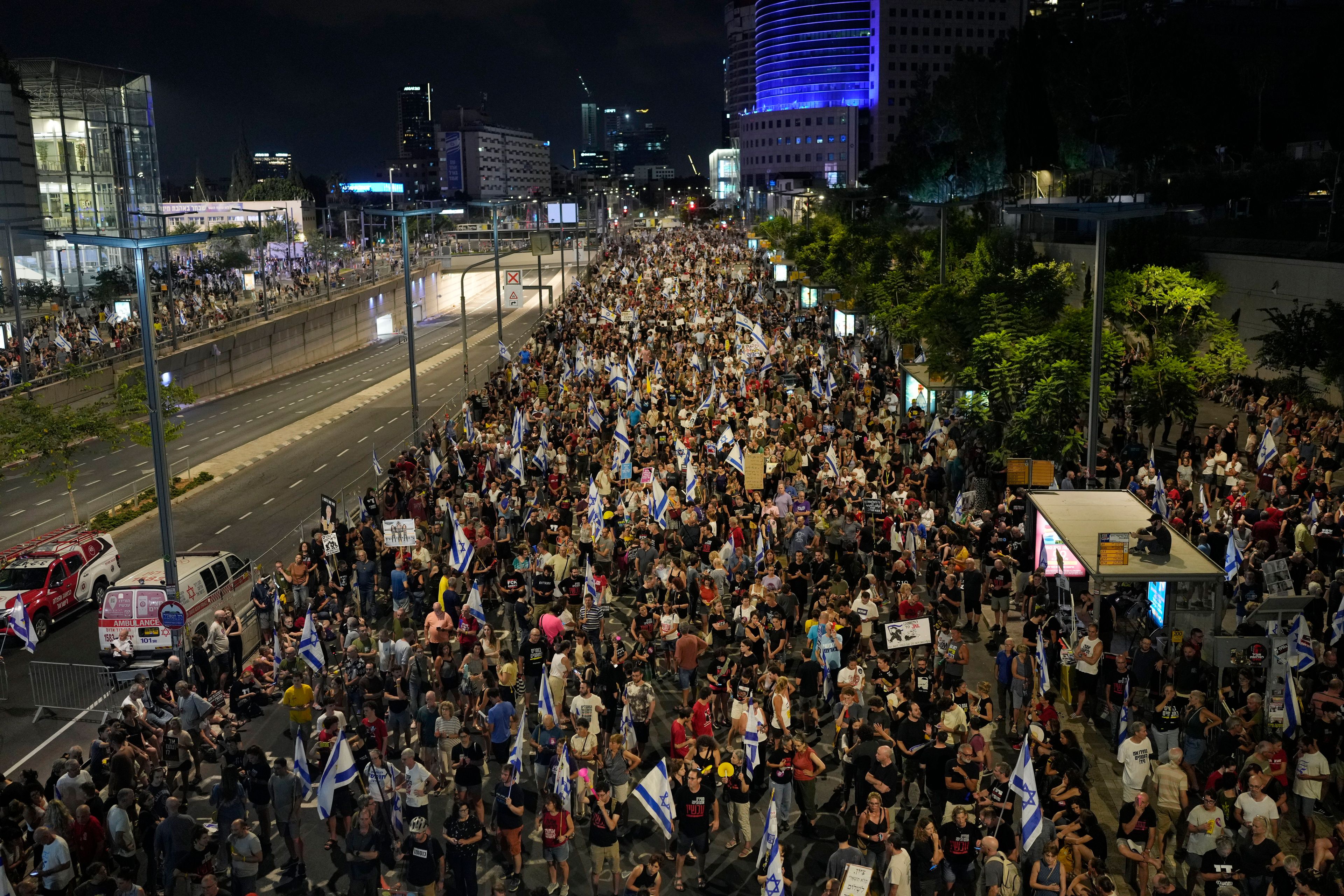 People protest against Israeli Prime Minister Benjamin Netanyahu's government and call for the release of hostages held in the Gaza Strip by the Hamas militant group in Tel Aviv, Israel, Saturday, Aug. 31, 2024. (AP Photo/Ohad Zwigenberg)