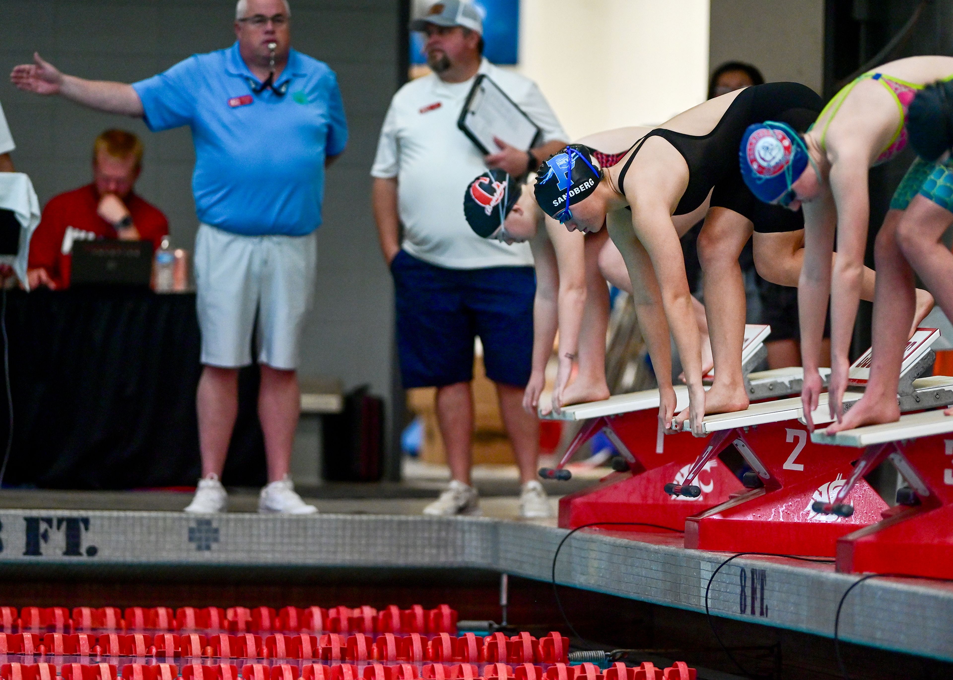 Swimmers competing in the 500-yard freestyle at the Eastern Washington District Swim Championship, including Pullman junior Maile Sandberg, prepare for the start of the heat at Washington State University in Pullman.