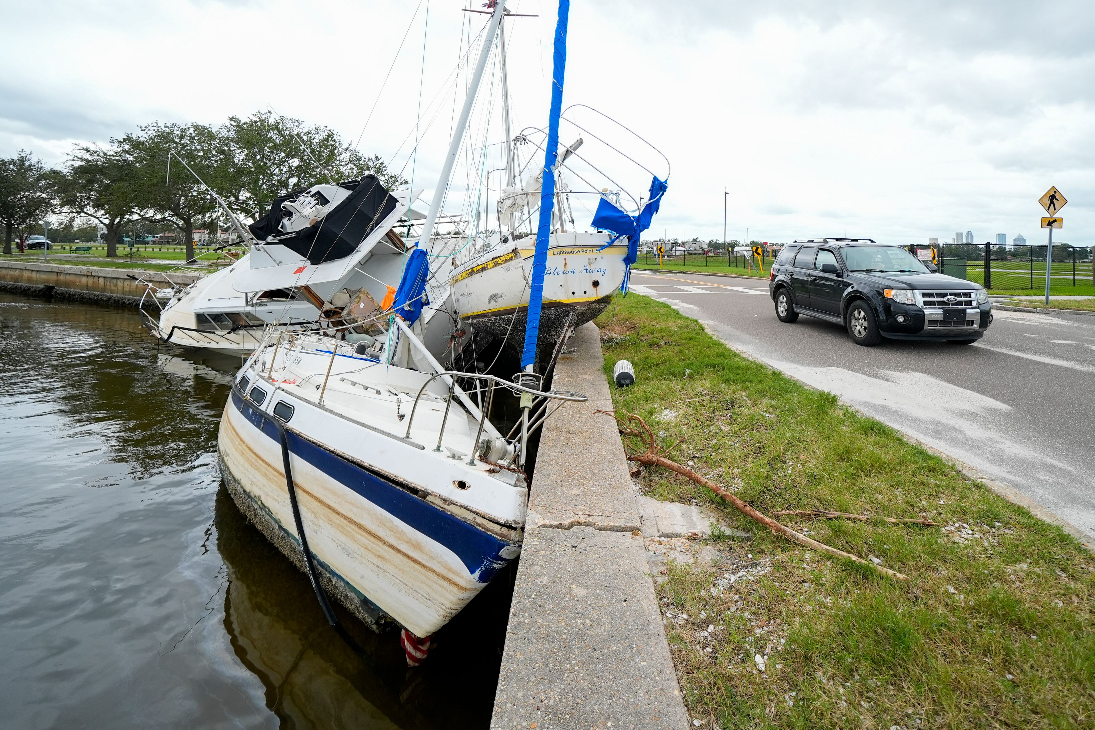 Boats are piled on the shore of the Davis Islands Yacht Basin in the Davis Islands community of Tampa, Fla., the day after Hurricane Milton hit the region, Thursday, Oct. 10, 2024. (AP Photo/Julio Cortez)