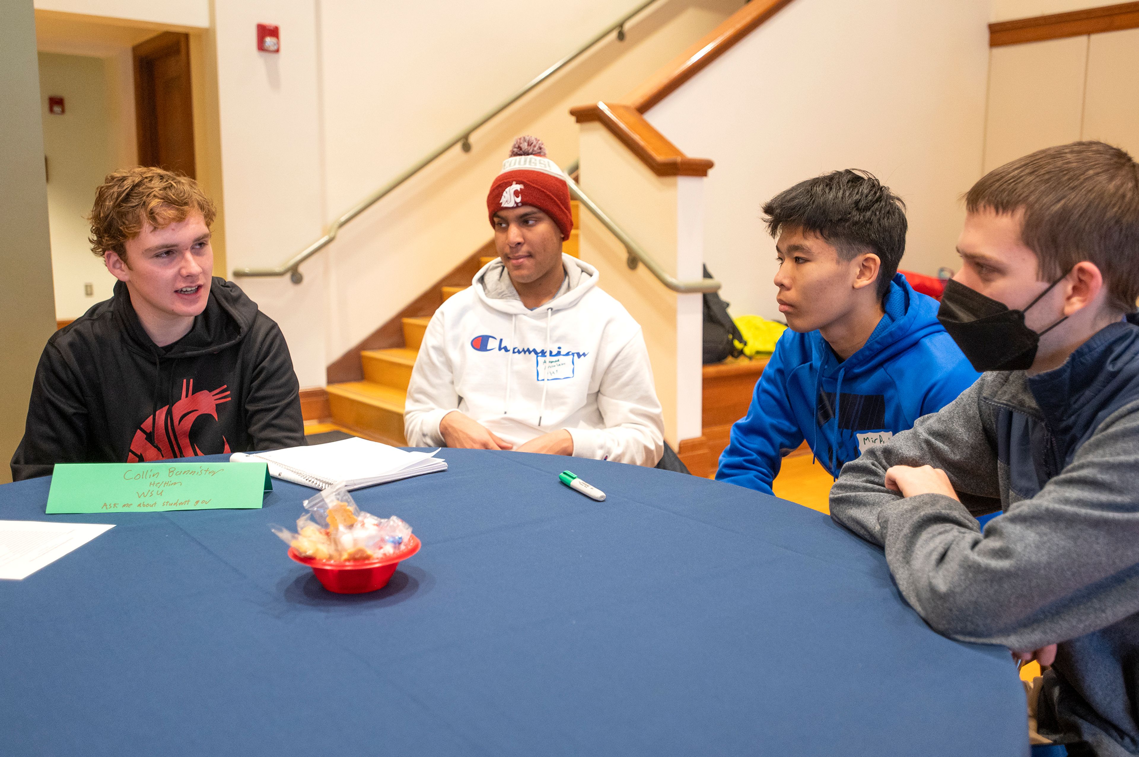 Collin Bannister, a student at Washington State University, left, speaks with local high school students about his college experience during a Palouse Pathways event at the 1912 Center in Moscow on Wednesday. Pullman High School student Lucas Mooney, right, said, “It’s been really helpful. It helps you understand what steps you have to take to get into college, and it’s nice to have a little structure when you don’t know what to do.”