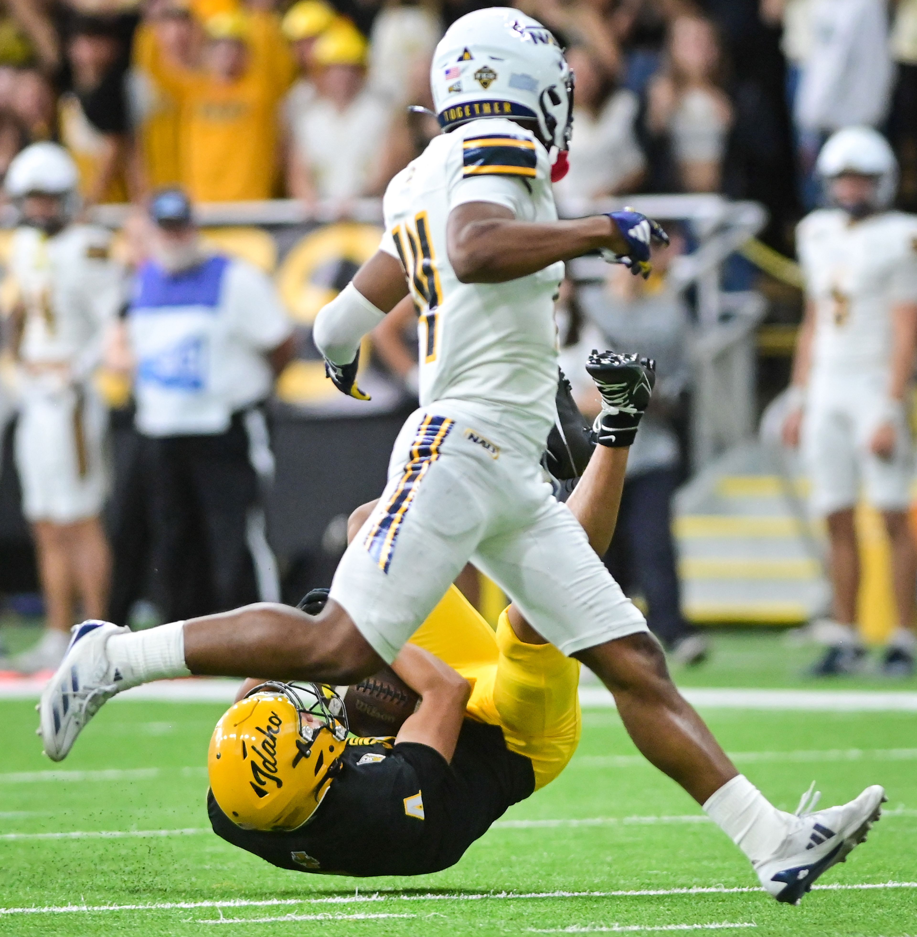 Idaho wide receiver Tony Harste lands on the ground to complete a pass from Idaho quarterback Nick Josifek during a game against Northern Arizona Saturday at the P1FCU Kibbie Dome in Moscow.,