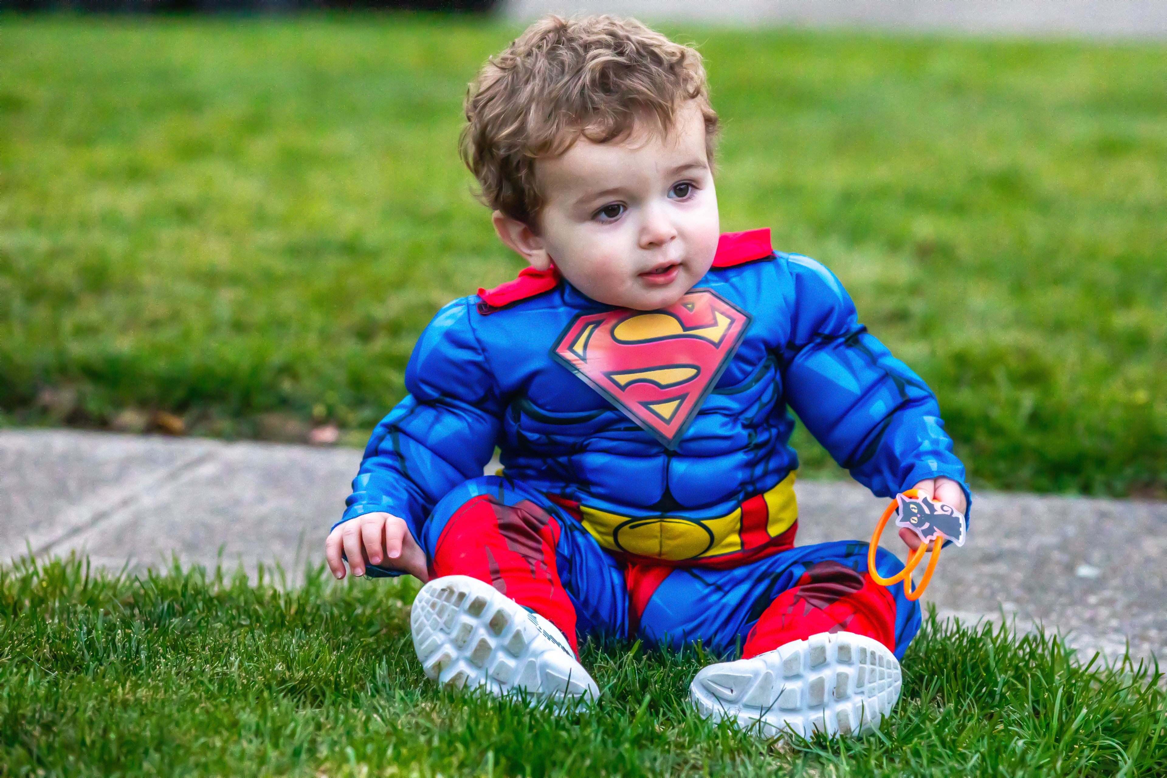 Hudson Freand, 1, of Lewiston, enjoys his first Halloween as the Man of Steel Thursday in the Sunset Drive neighborhood in Lewiston.