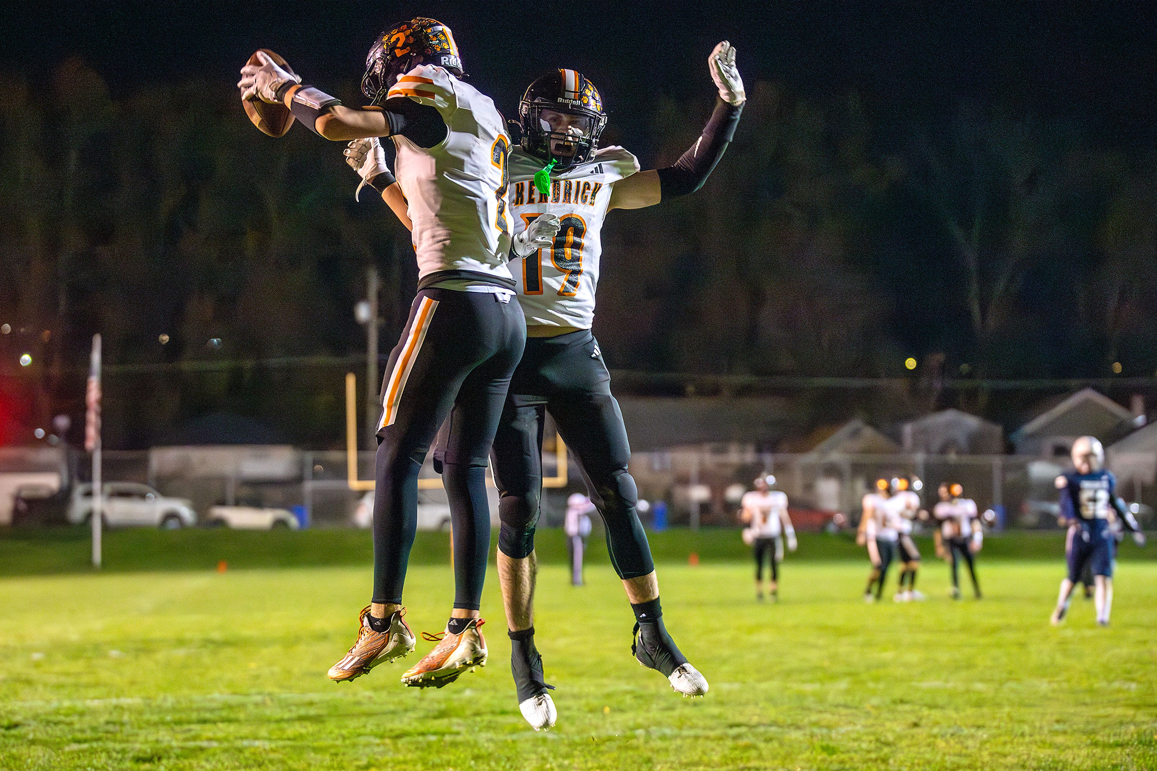 Kendrick wide receiver Ralli Roetcisoender, left, celebrates a touchdown with Sawyer Hewett against Logos in a semifinal game of the Idaho State Football Class 2A Championships Friday at Bengal Field in Lewiston.