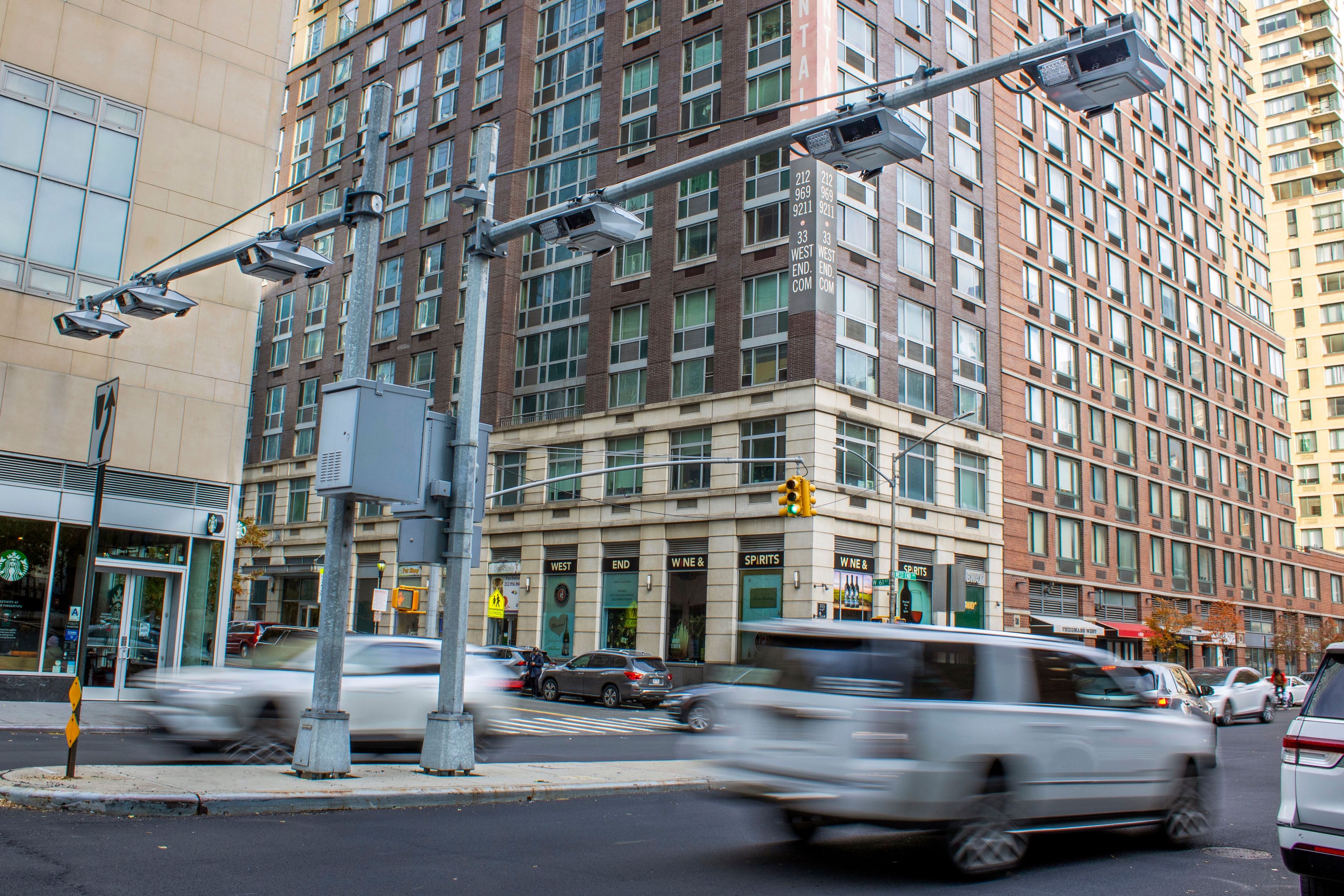 FILE - Recently installed toll traffic cameras hang above West End Ave. near 61st Street in the Manhattan borough of New York, Nov. 16, 2023. New York Gov. Kathy Hochul is trying to raise taxes on businesses in the city to close a big budget gap that emerged after she halted a plan to charge drivers a toll to enter the center of Manhattan.