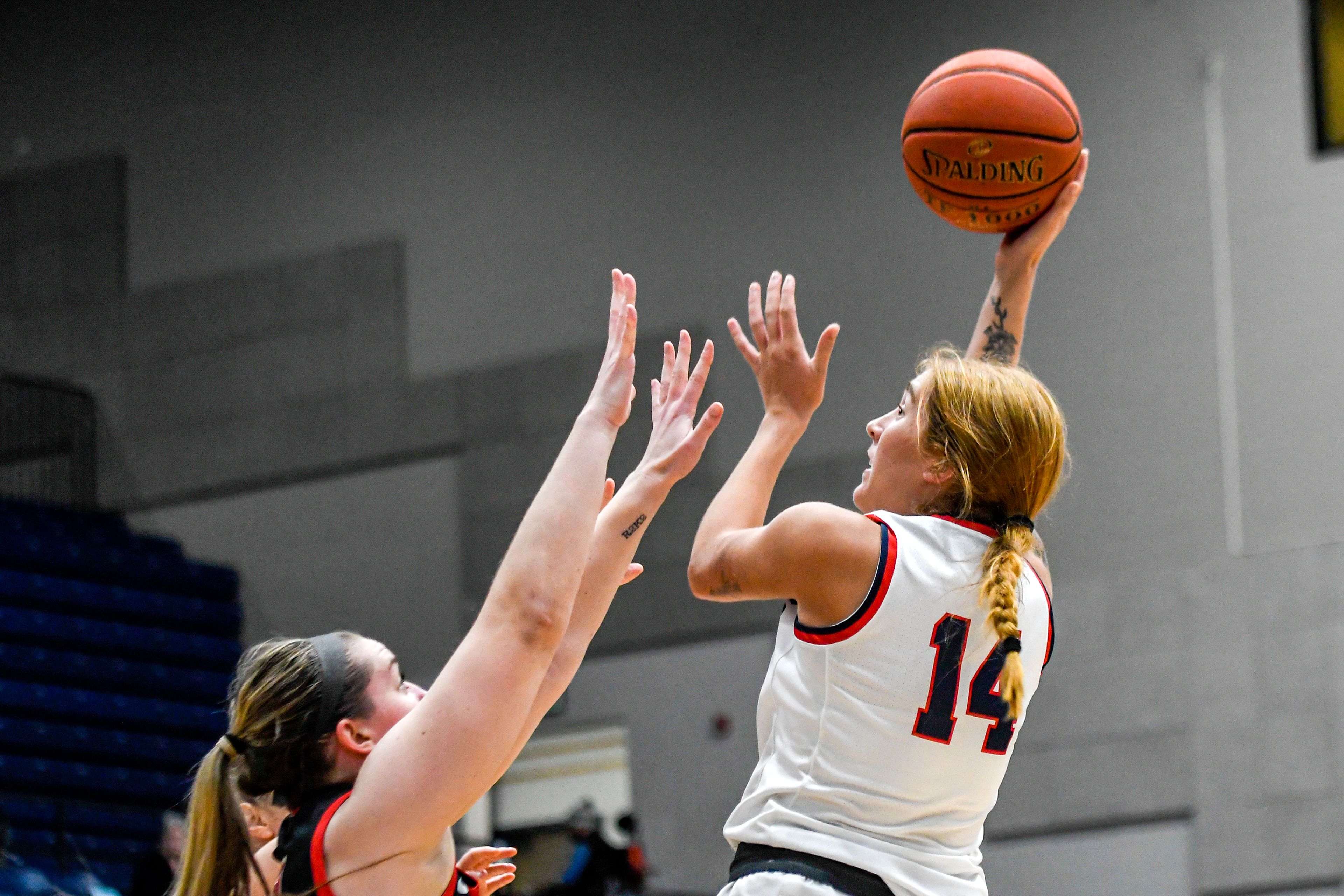 Lewis-Clark State forward Maddie Holm, left, puts up a hook shot Saturday during a Cascade Conference game against Southern Oregon at the P1FCU Activity Center.