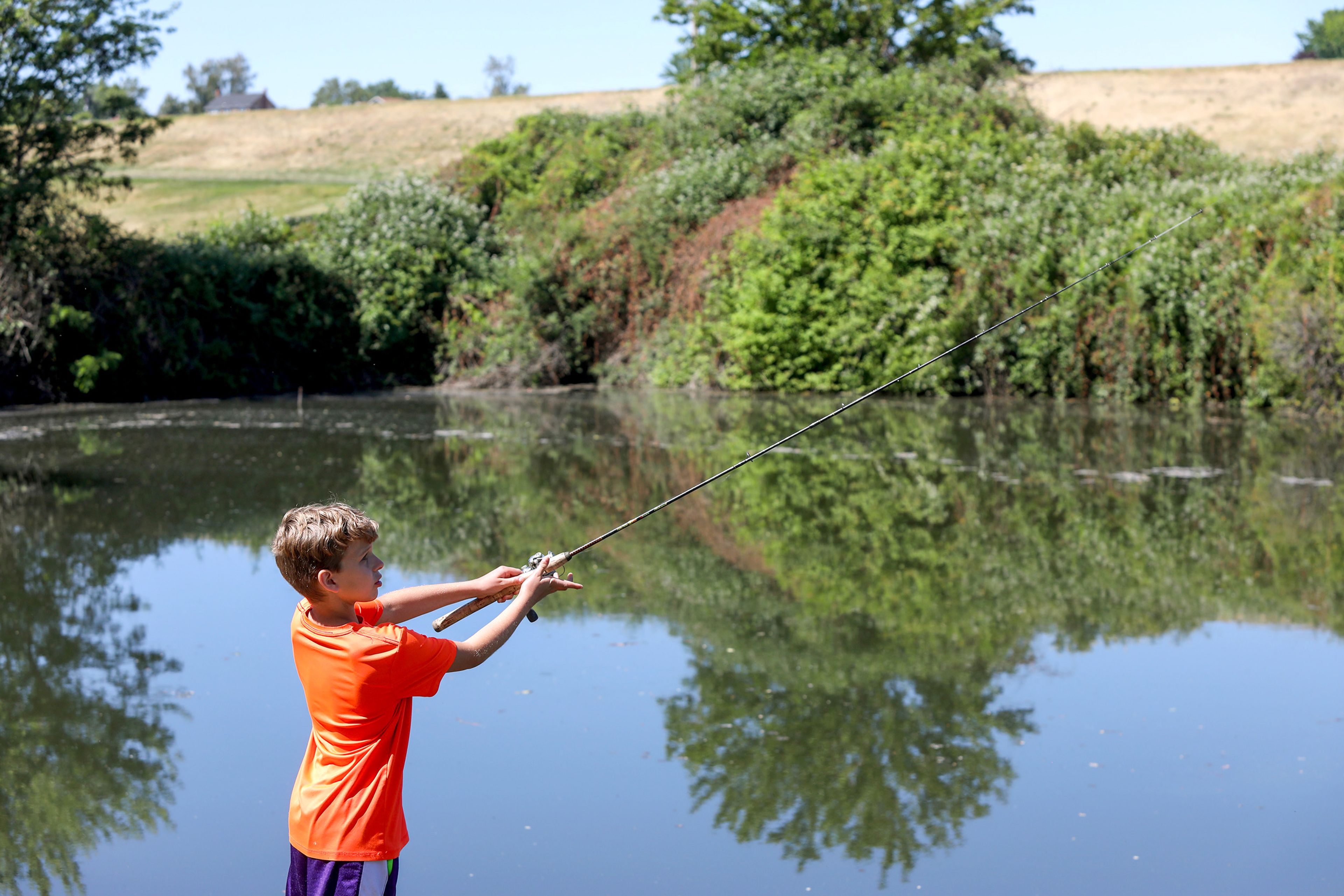 Jameson Reed, 12, of Lewiston, throws out a fishing line at Kiwanis Park Pond on Saturday, Idaho's Free Fishing Day, in Lewiston. Reed was hoping to continue his winning streak after catching a few fish the day before.