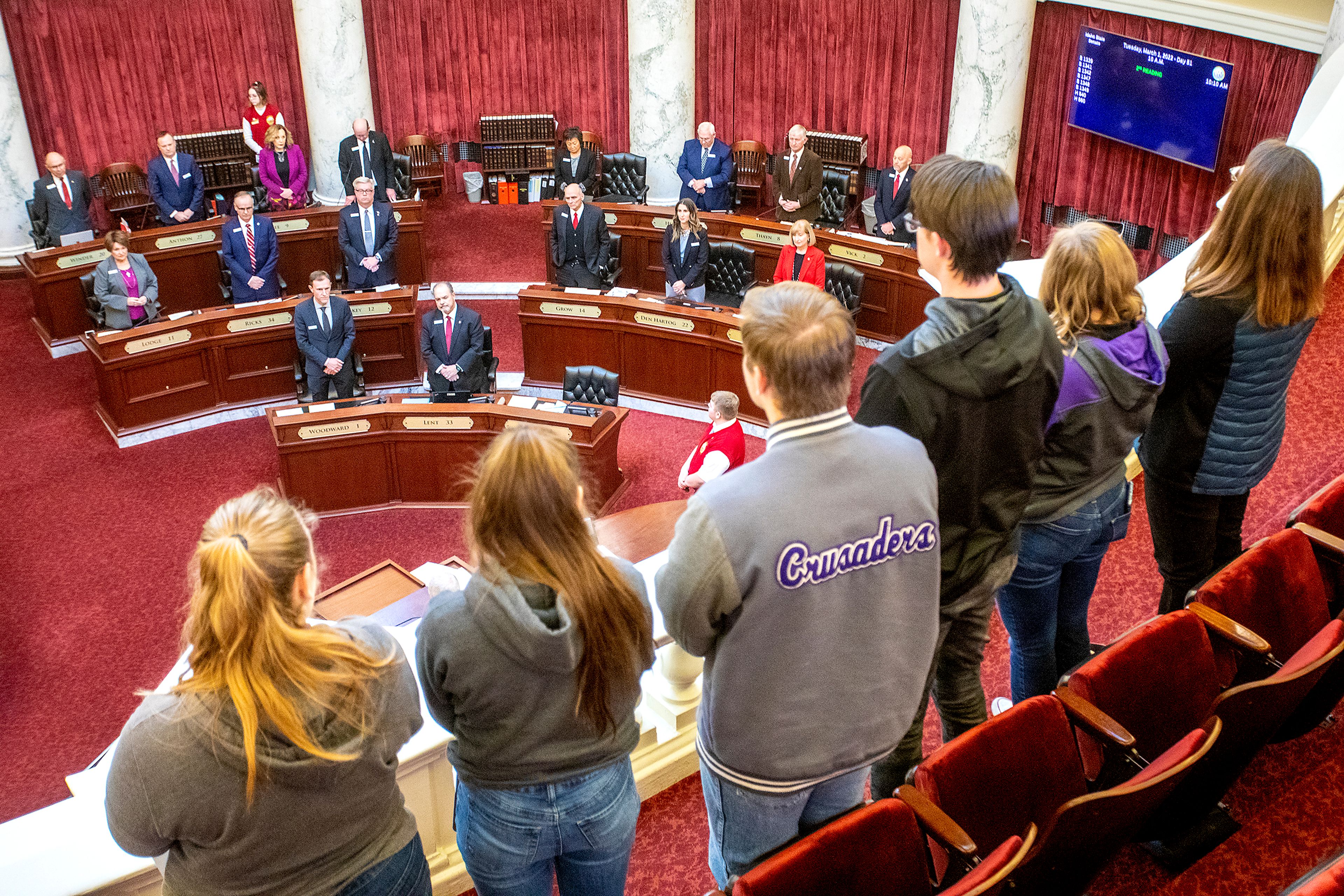 The senate stands for prayer before the start of daily session at the Idaho State Capital in Boise on Tuesday.