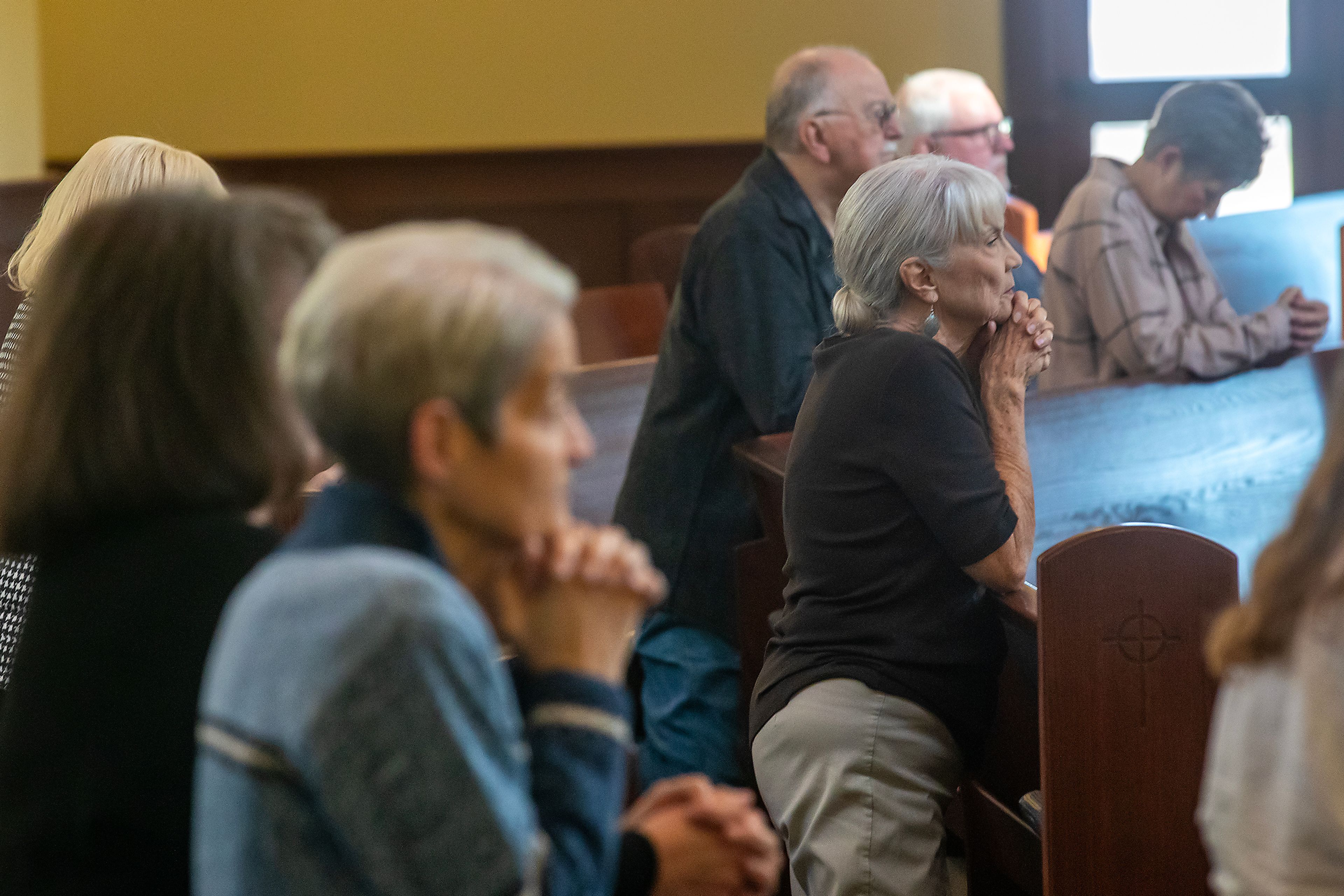 Parishioners kneel during Mass on Wednesday at All Saints Catholic Church in the Lewiston Orchards.