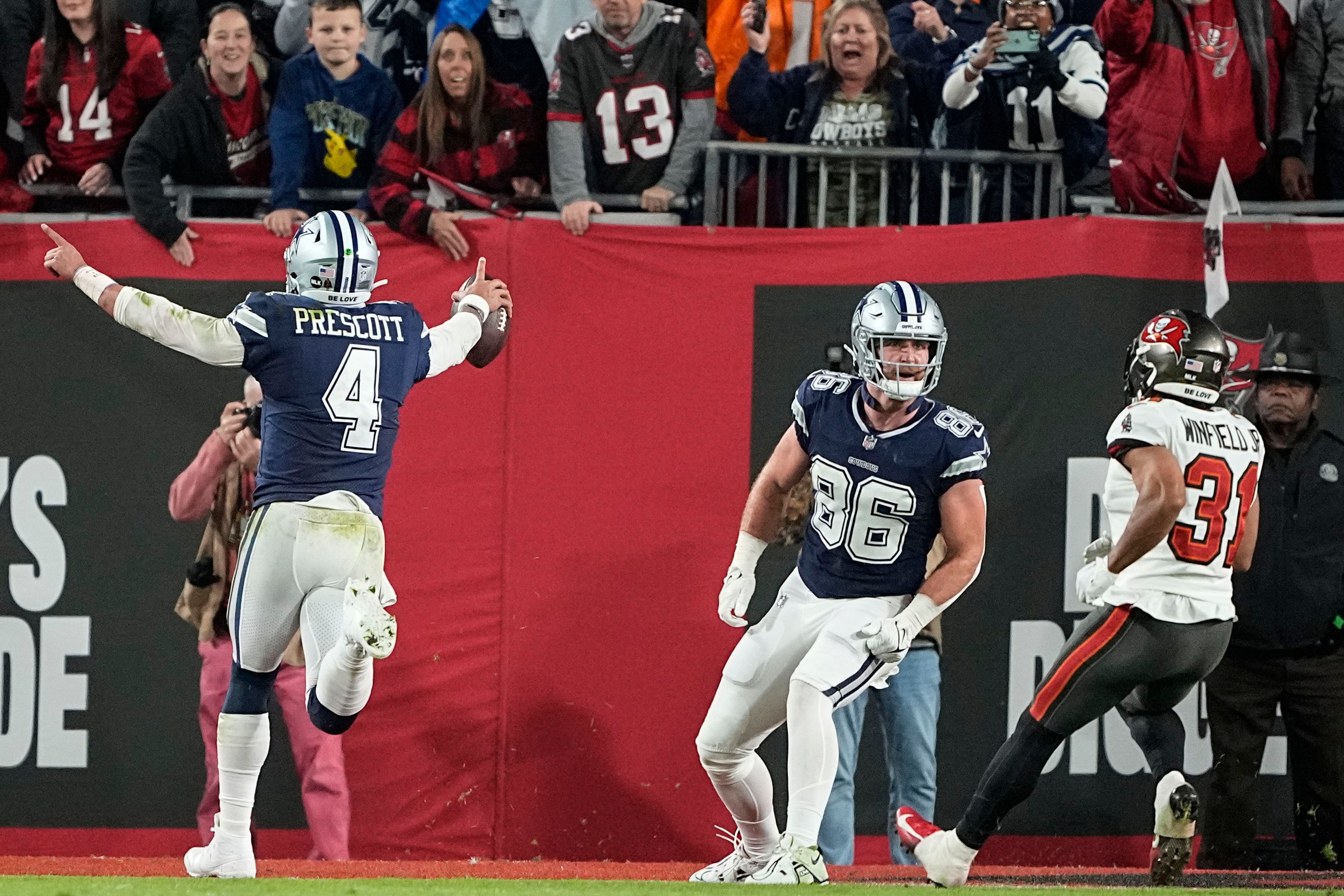 Dallas Cowboys quarterback Dak Prescott (4) runs into the end zone for a touchdown against the Tampa Bay Buccaneers during the first half of an NFL wild-card football game, Monday, Jan. 16, 2023, in Tampa, Fla. (AP Photo/Chris Carlson)