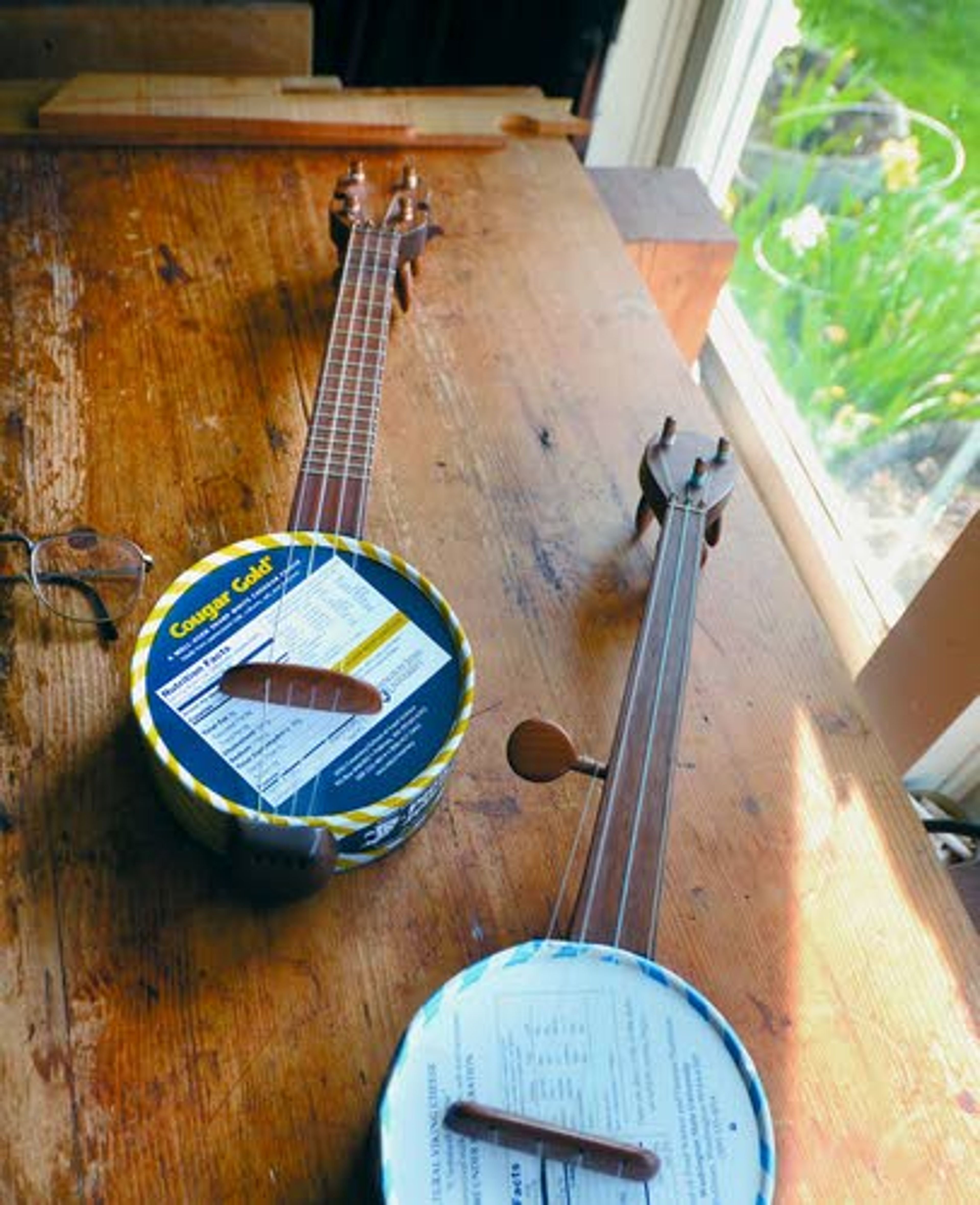 Tribune/Barry KoughJohn Elwood made sturdy canjos from Cougar Gold cheese cans.