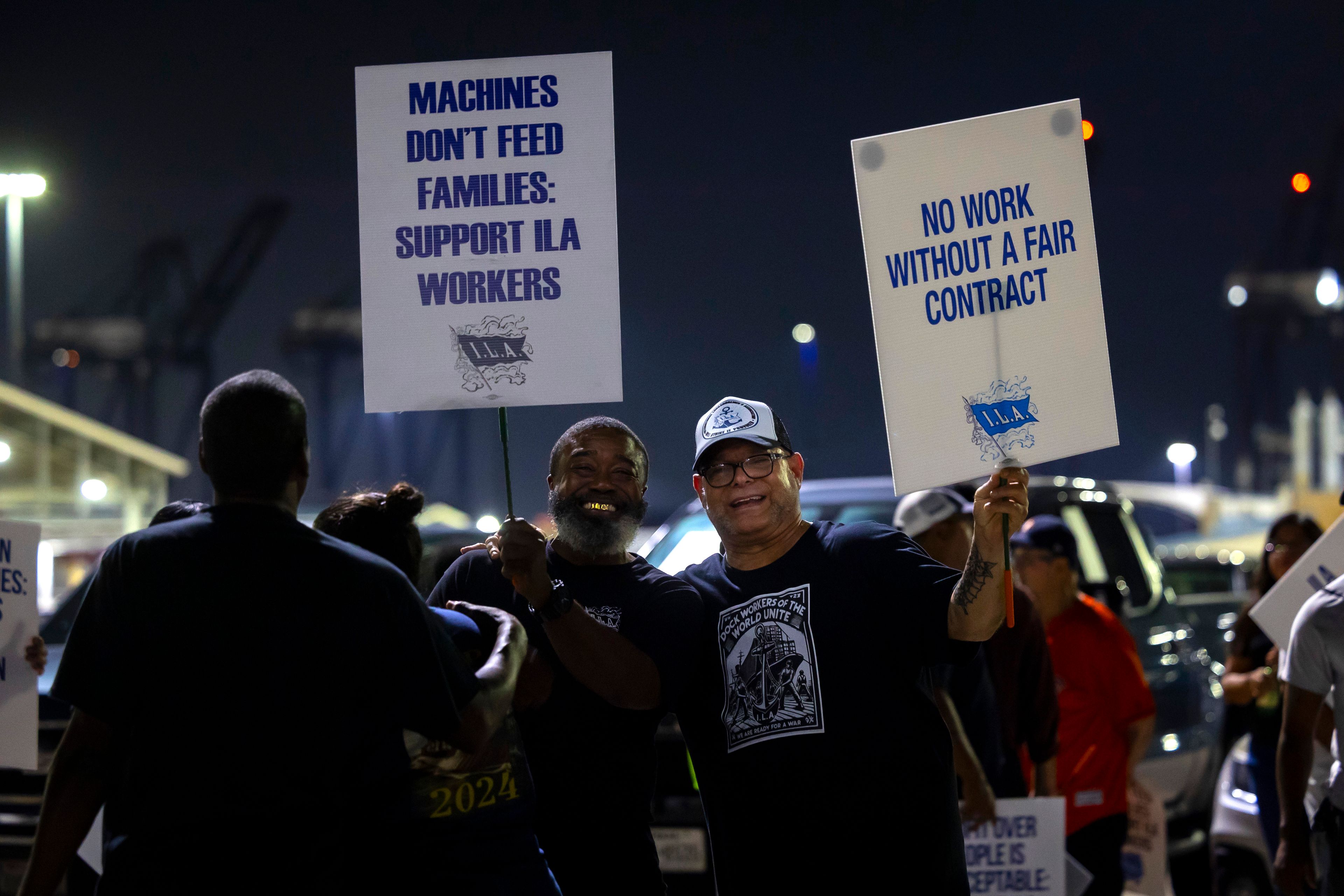 Longshoremen pose for a photo while picketing at Bayport Terminal on Tuesday, Oct. 1, 2024, in Houston. (AP Photo/Annie Mulligan)