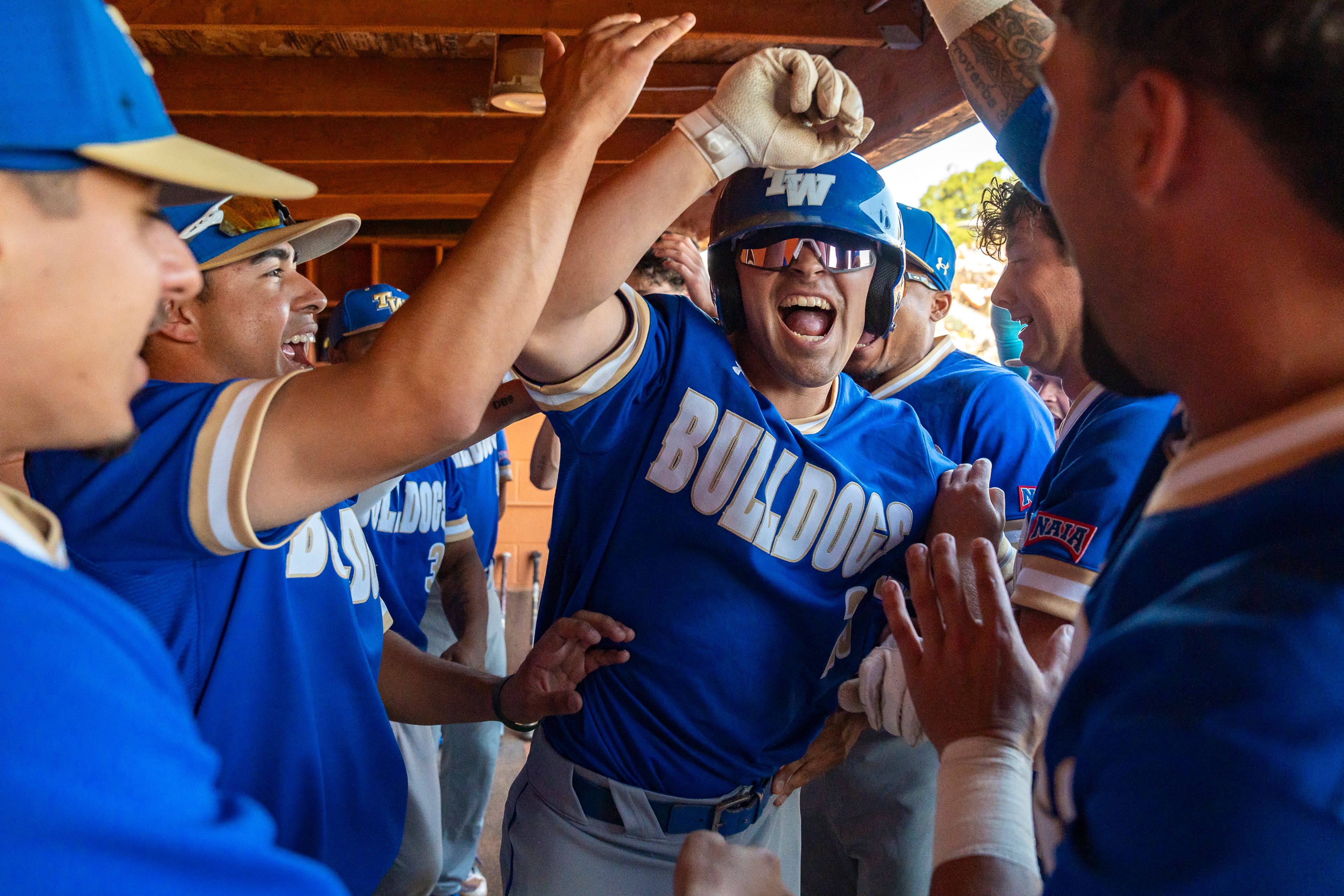 Tennessee Wesleyan’s Julian Berinti celebrates in the dugout after hitting a home run during Game 19 of the NAIA World Series against Reinhardt on Friday at Harris Field in Lewiston.