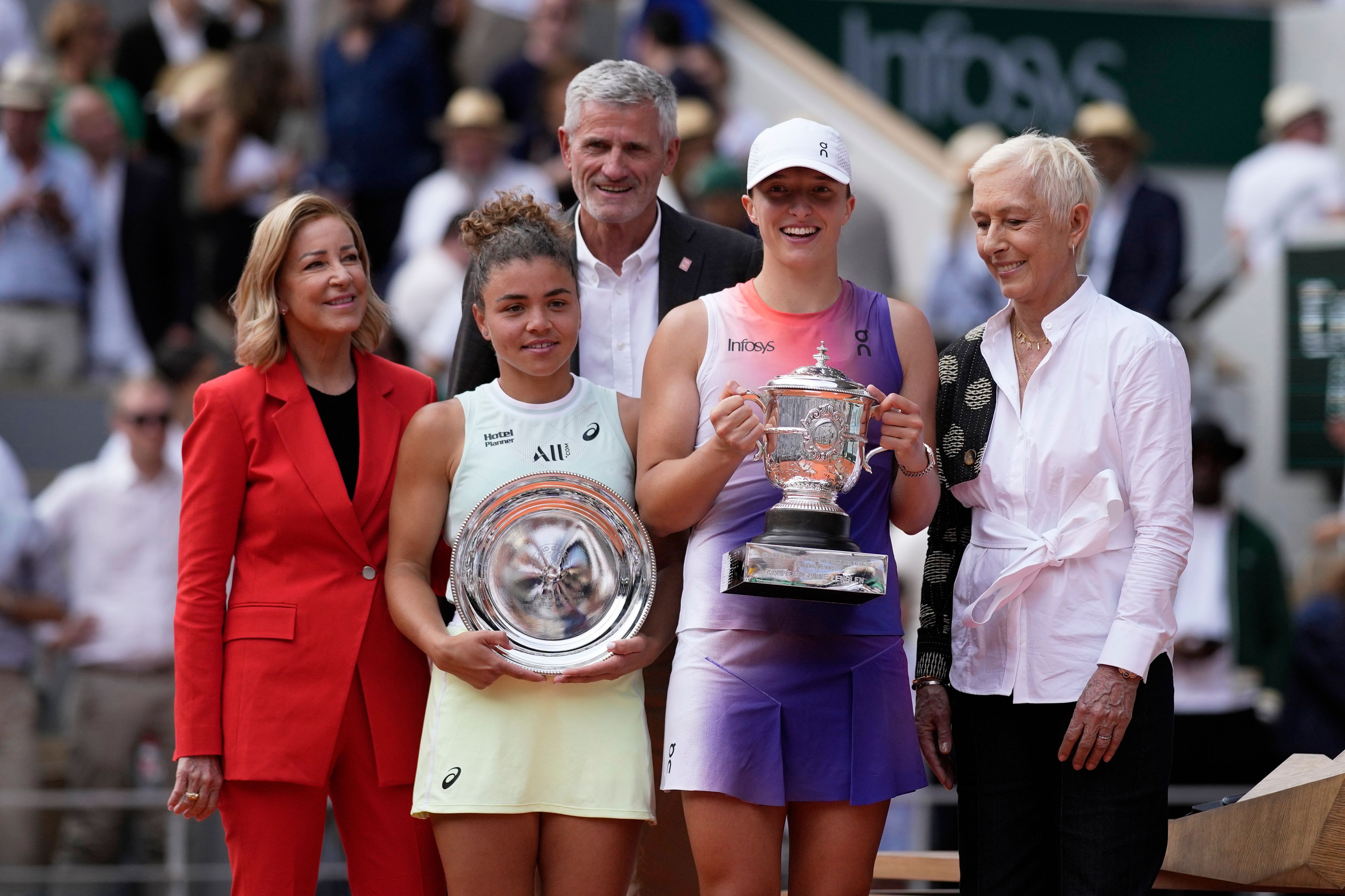 Winner Poland's Iga Swiatek, centre right, and second placed Italy's Jasmine Paolini, centre left, pose for a picture with trophies after their women's final of the French Open tennis tournament at the Roland Garros stadium in Paris, France, Saturday, June 8, 2024.