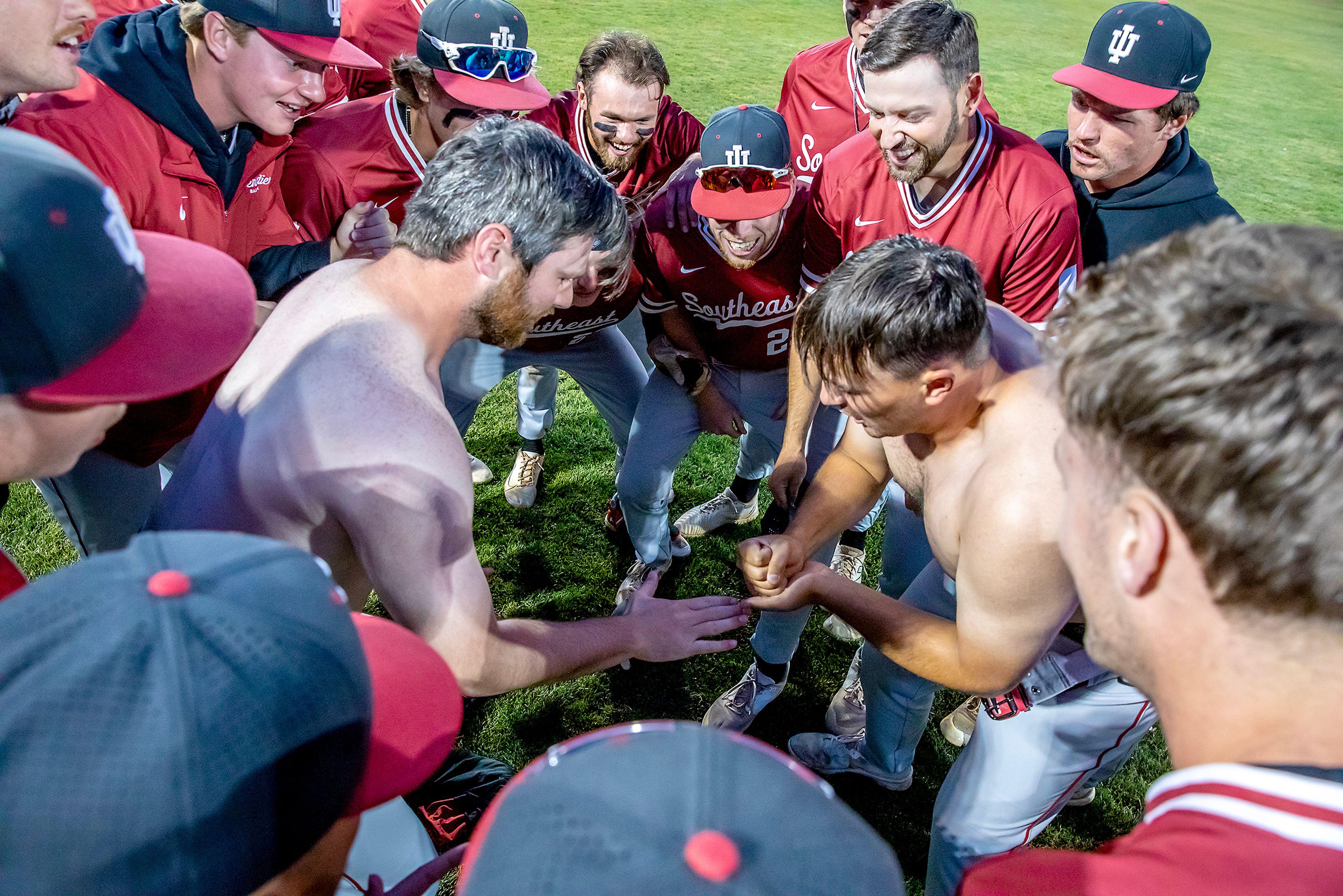 Indiana Southeast players play rock, paper, scissors after ripping their shirts off in a pregame ritual Friday, May 24, at Harris Field ahead of their game against William Carey at the NAIA World Series in Lewiston.