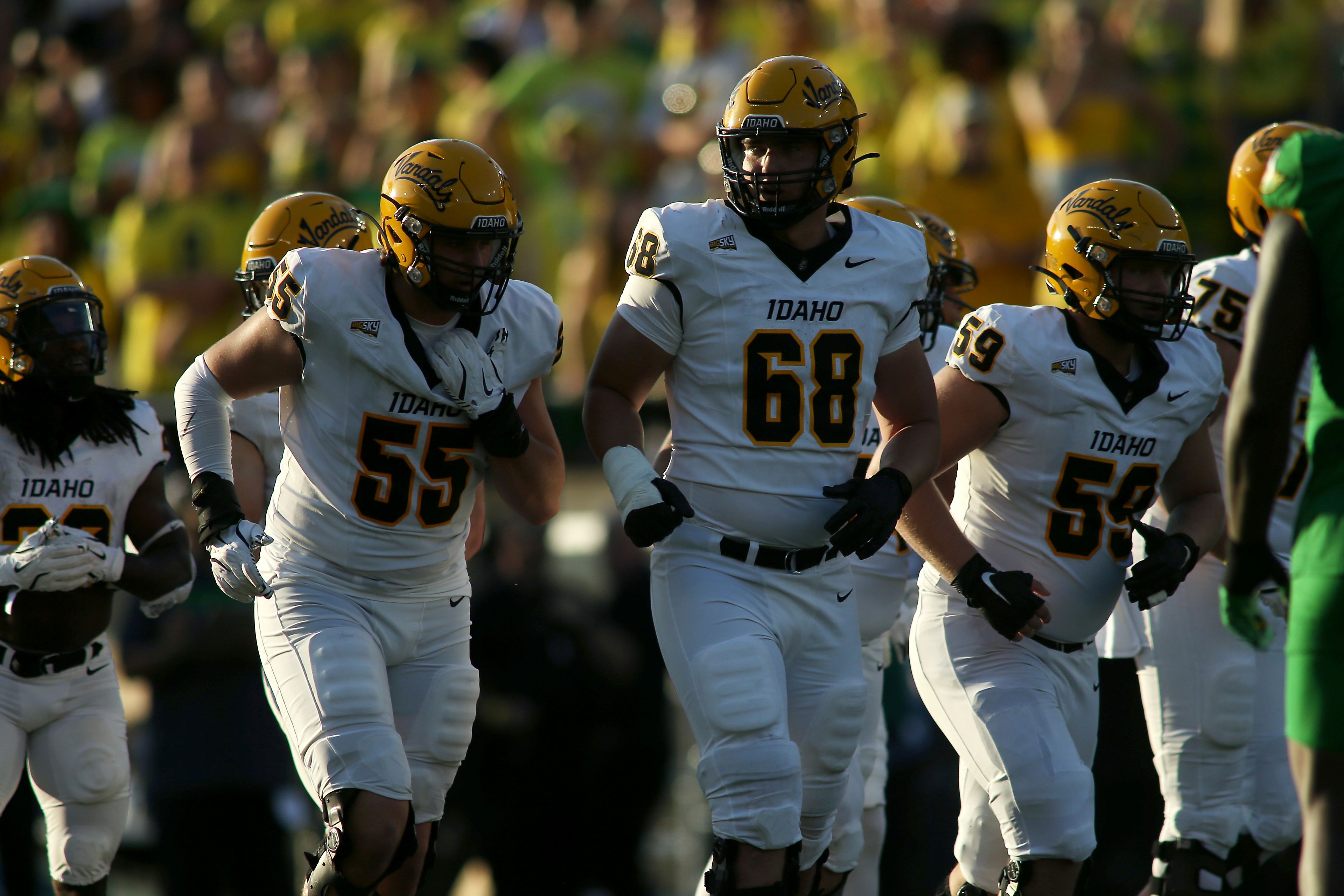 Idaho offensive linemen Jack Foster (55), Charlie Vliem (68) and Kaden Robnett (59) line up before a play during the second half of an NCAA college football game against Oregon, Saturday, Aug. 31, 2024, in Eugene, Ore. (AP Photo/Lydia Ely)