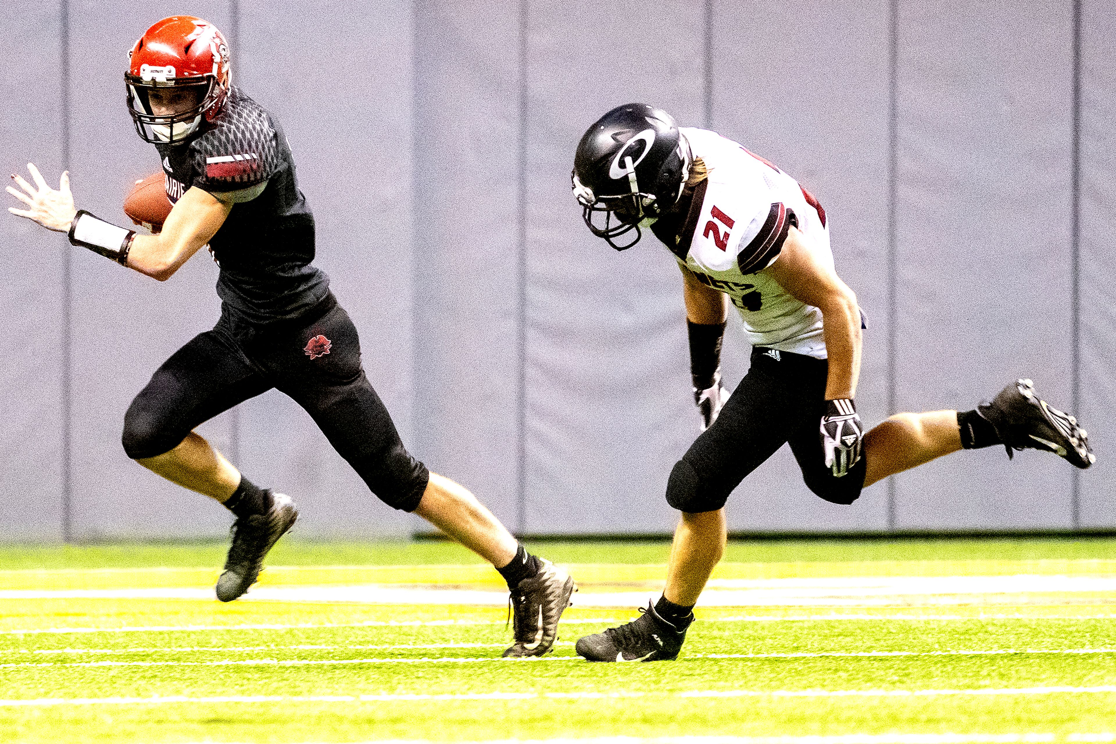 Prairie’s Cole Schlager outruns Oakley’s Robersons Wybenga as he looks for a teammate to pass too. The Prairie Pirates lost to the Oakley Hornets 42-40 in the Class 1A Division O state semifinal football game at the Kibbie Dome in Moscow on Friday.