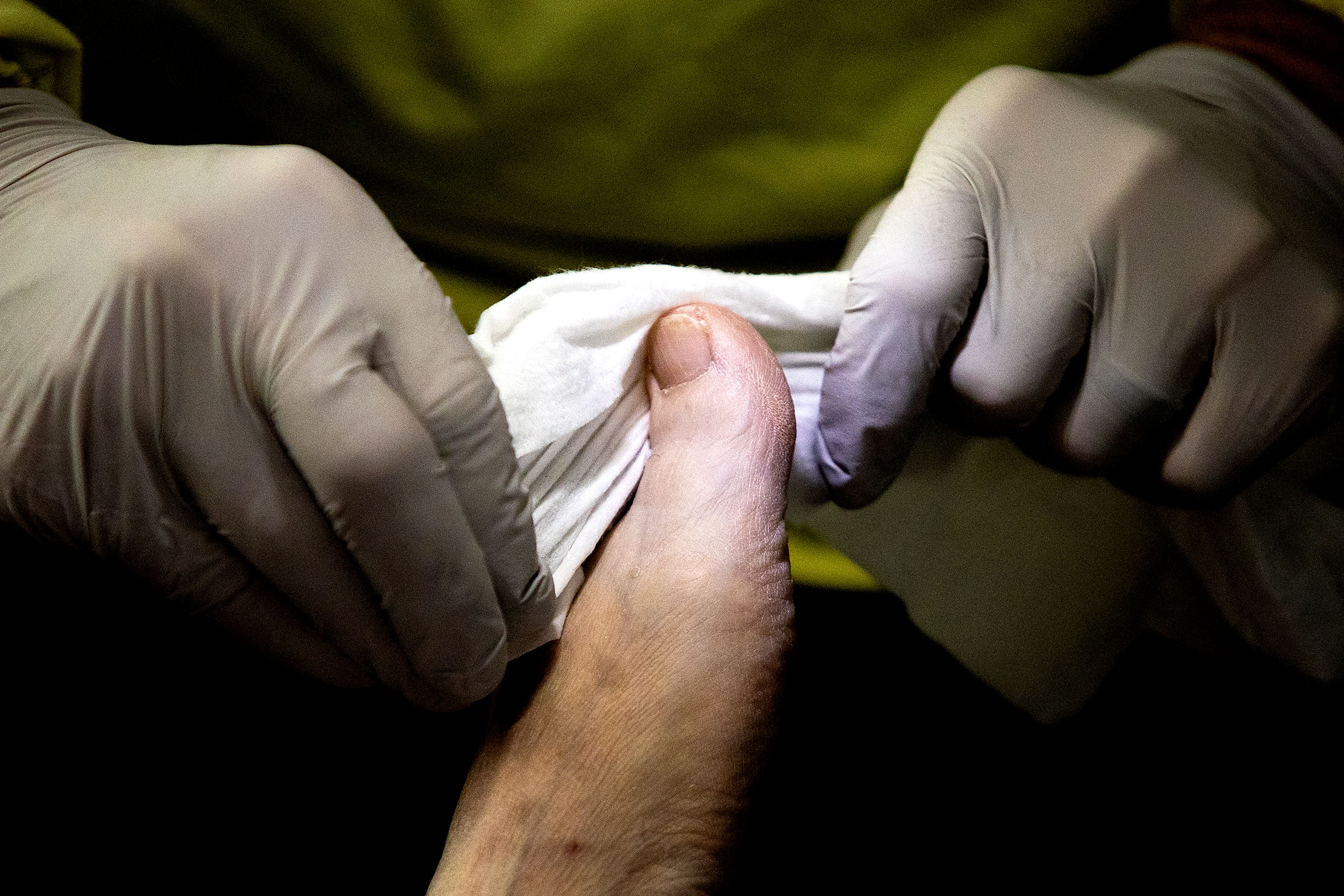 Nurse Aaron Loudenback wipes off the feet of Mary Lou Gregory in February.