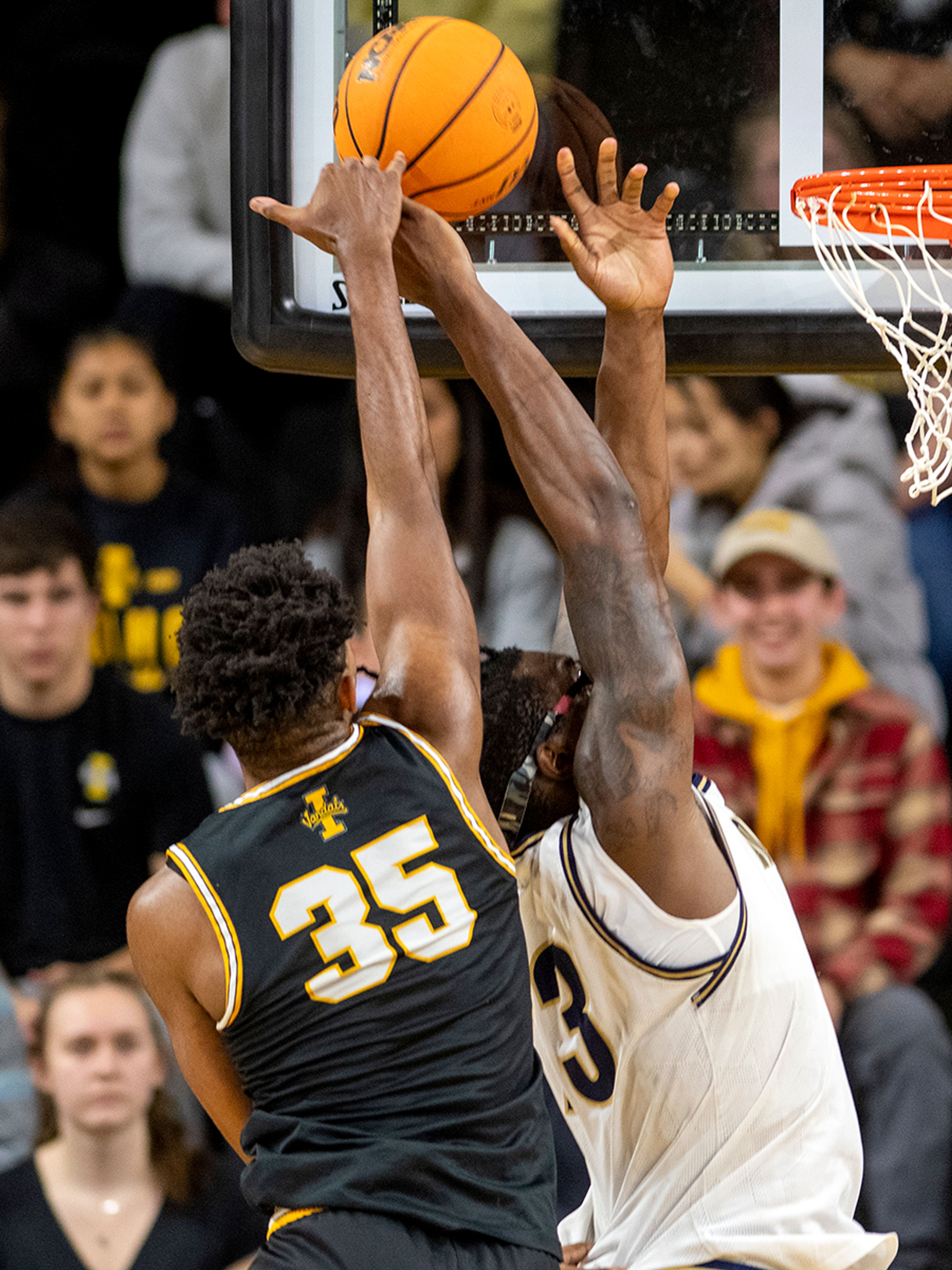 Idaho forward Nigel Burris blocks a layup attempt by Montana State forward Jubrile Belo during the second half of Monday’s Big Sky Conference game at Idaho Central Credit Union Arena.